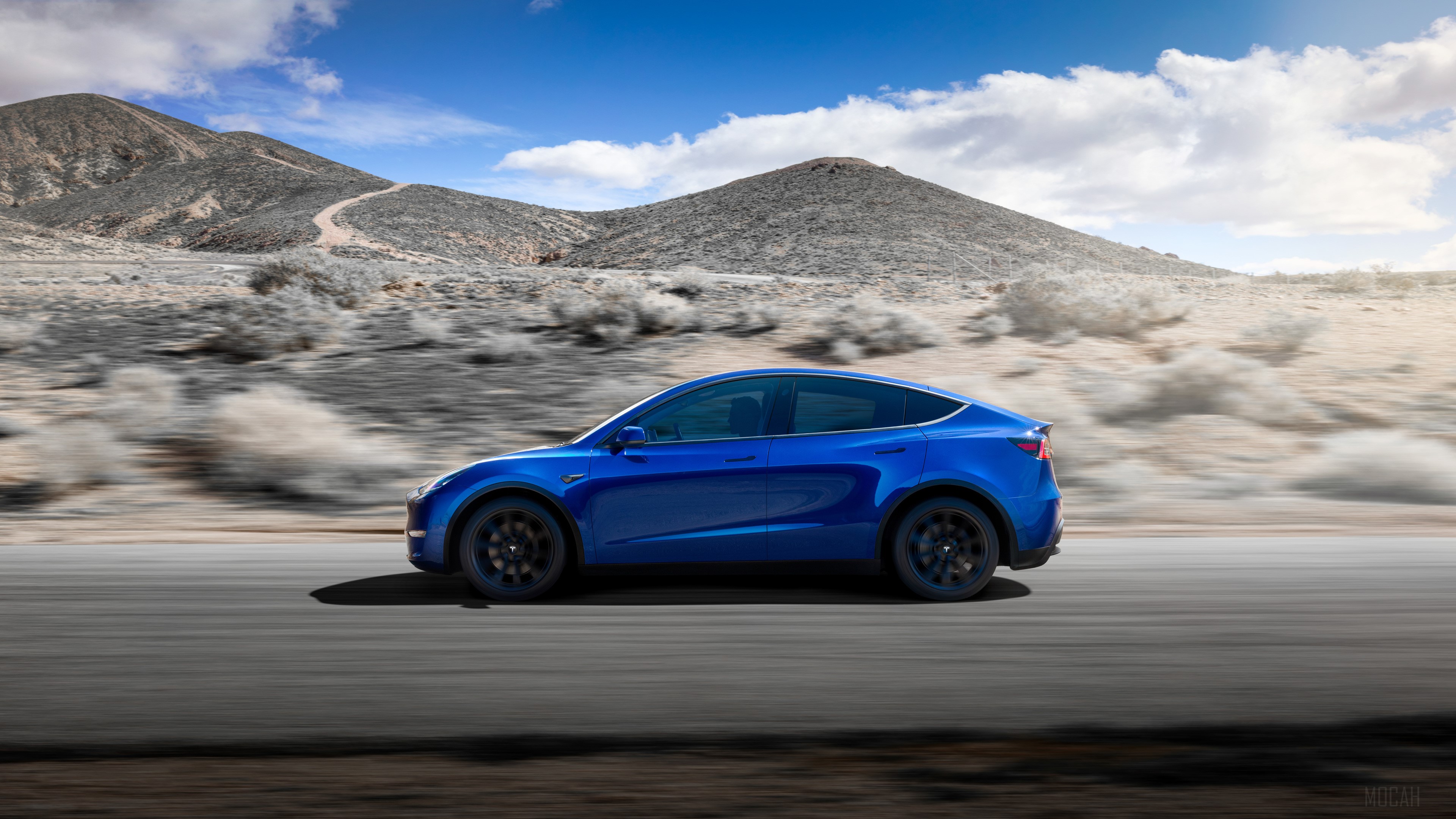 Blue 2019 Tesla Model Y driving on a road HD Wallpaper