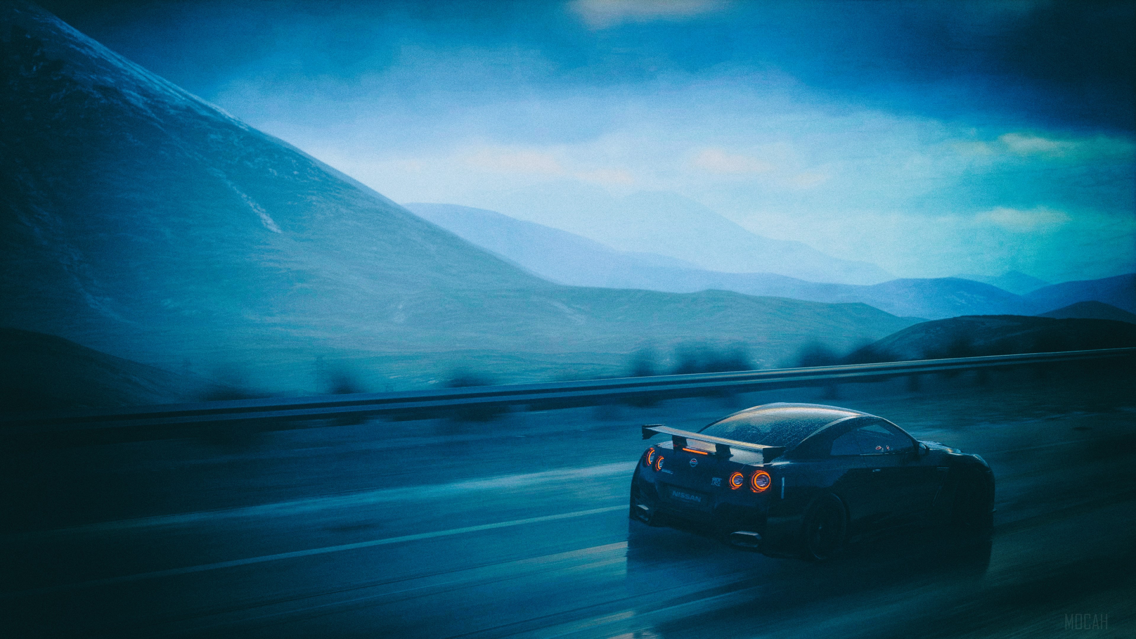Nissan GTR driving on a wet road with mountains HD Wallpaper