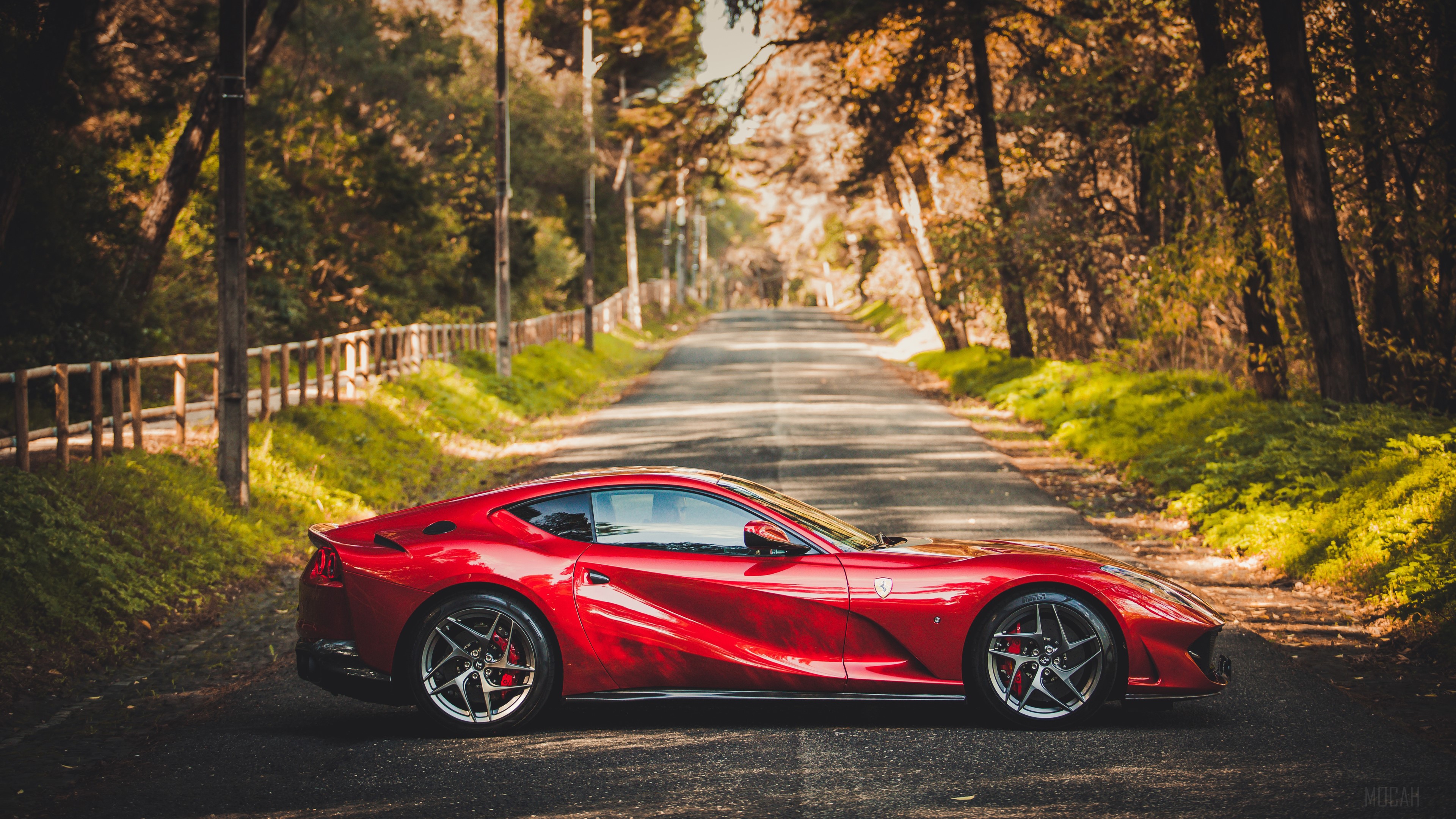 Red Ferrari 812 Superfast on a Tree-Lined Road 4K HD Wallpaper