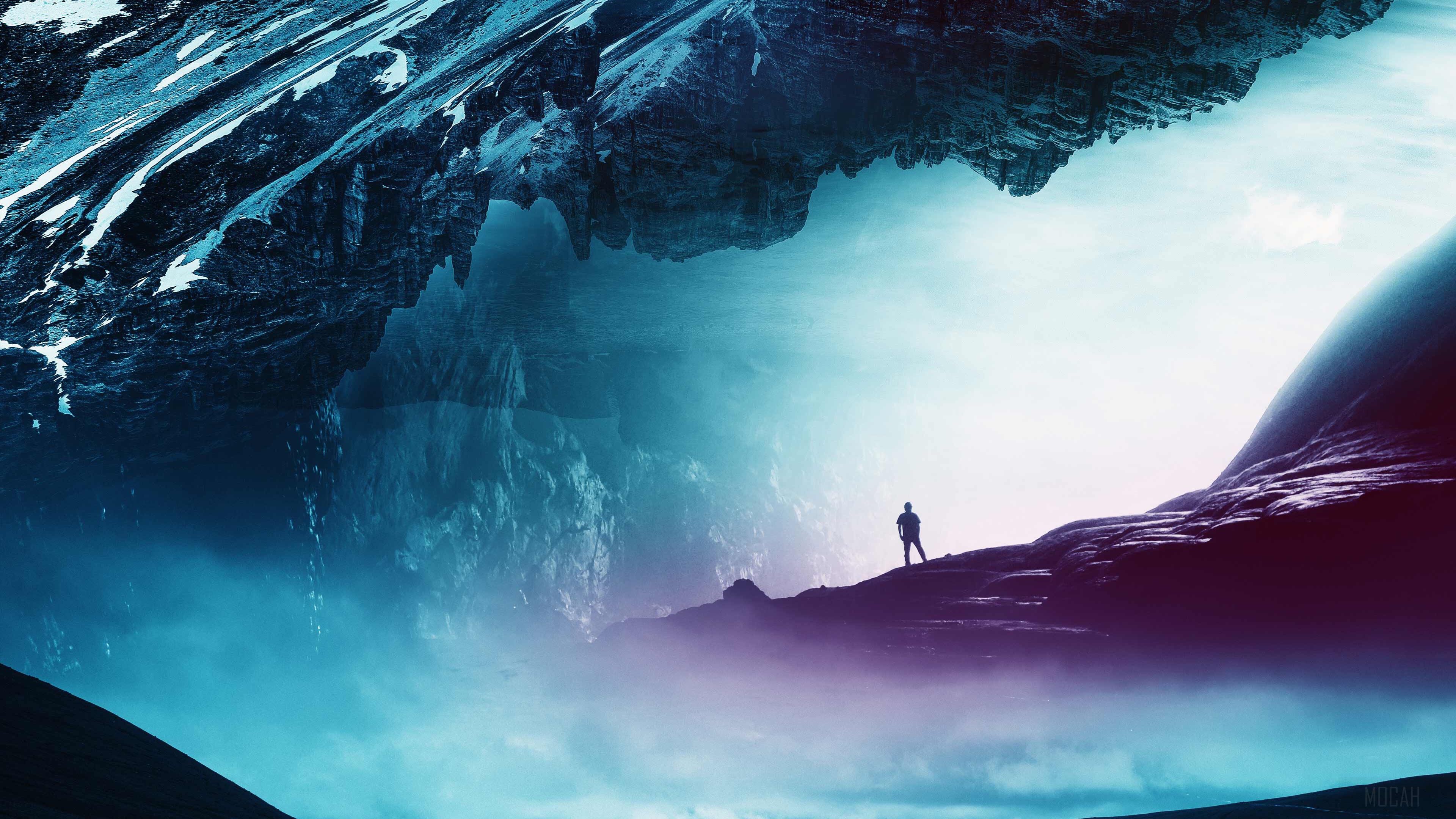 Man standing on a mountain ridge in a surreal landscape HD Wallpaper