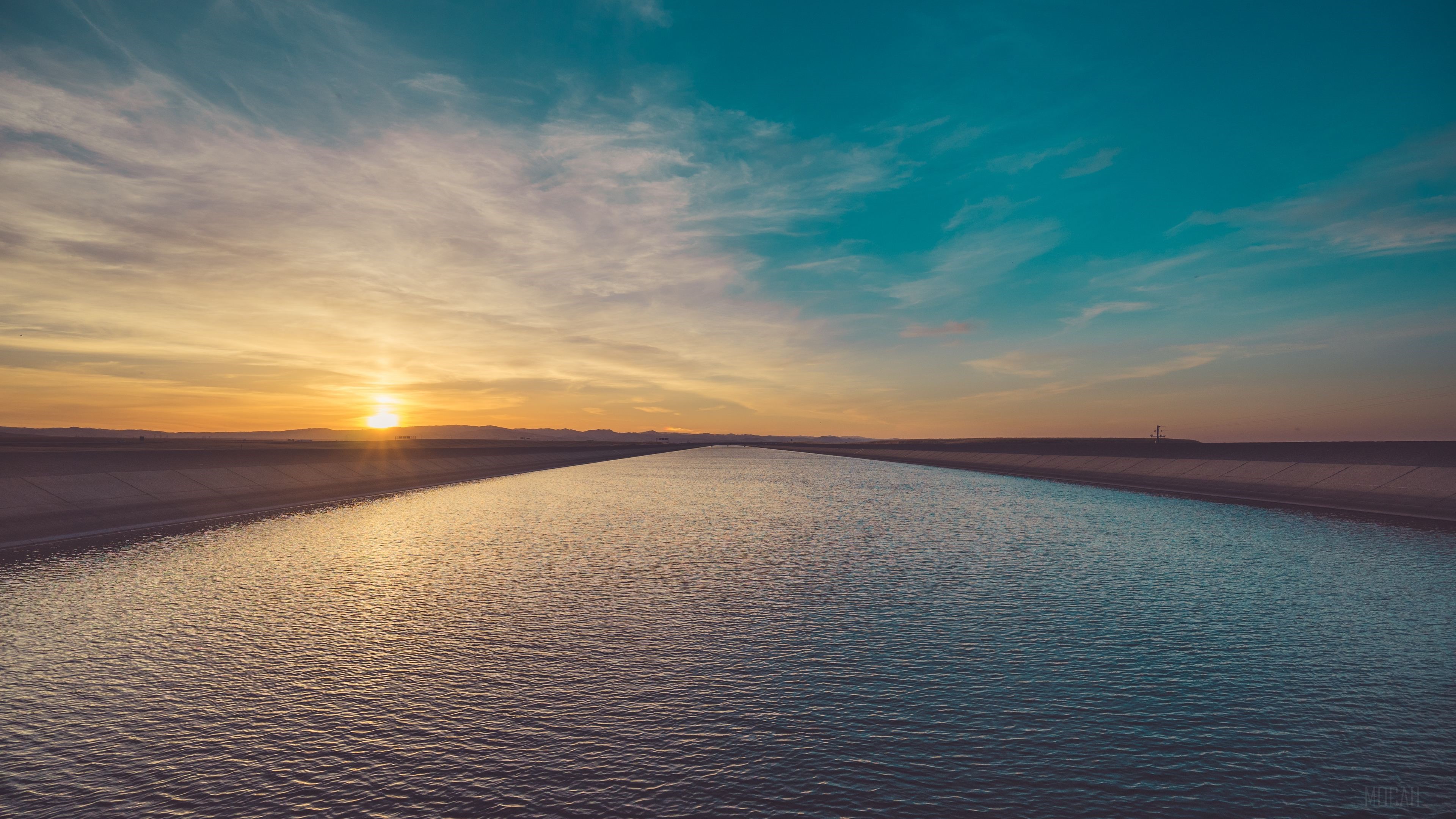Sunset Over Calm River with Expansive Sky 4K HD Wallpaper