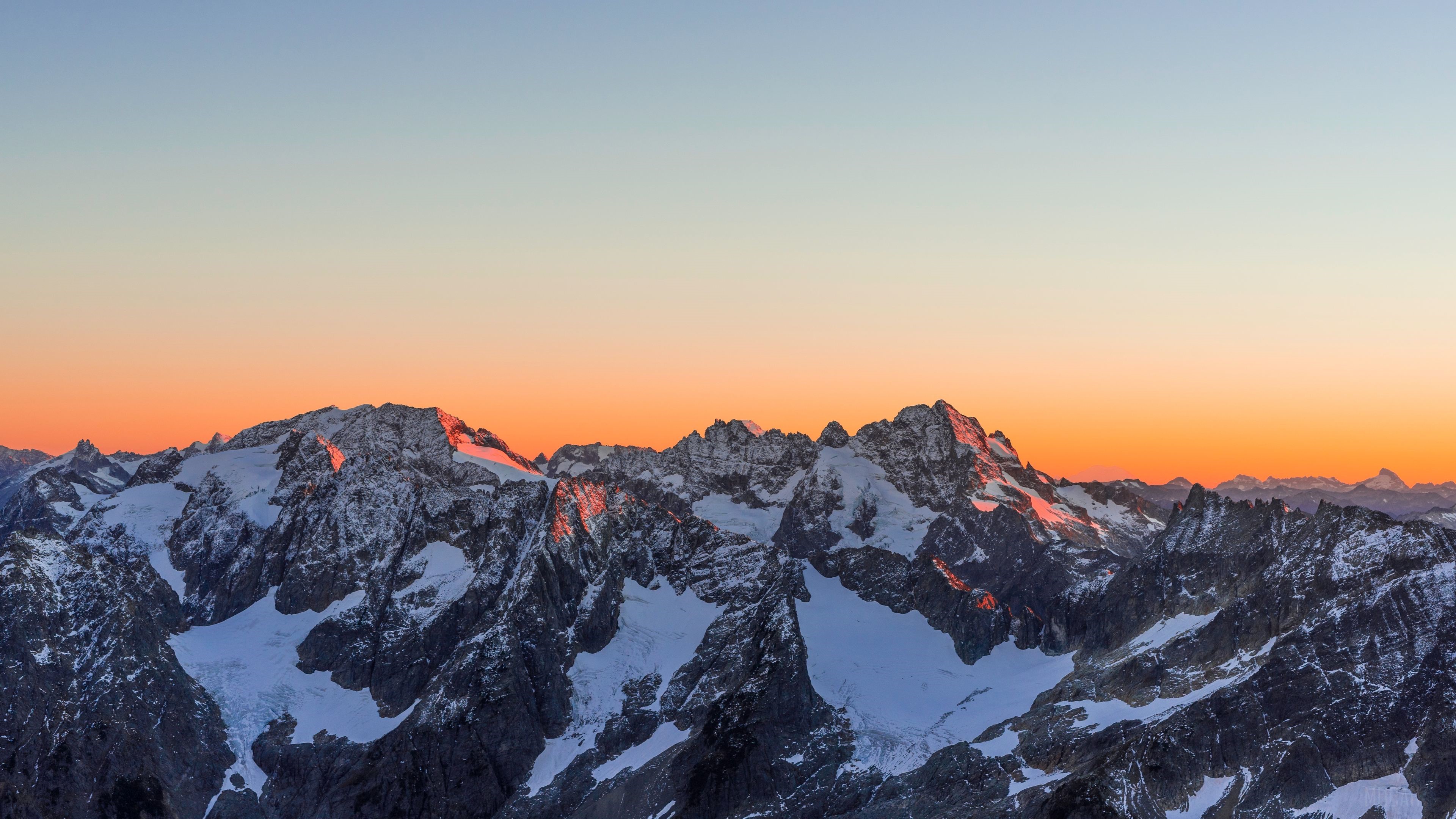 Sunset Over Snow-Covered Mountains 4K HD Wallpaper