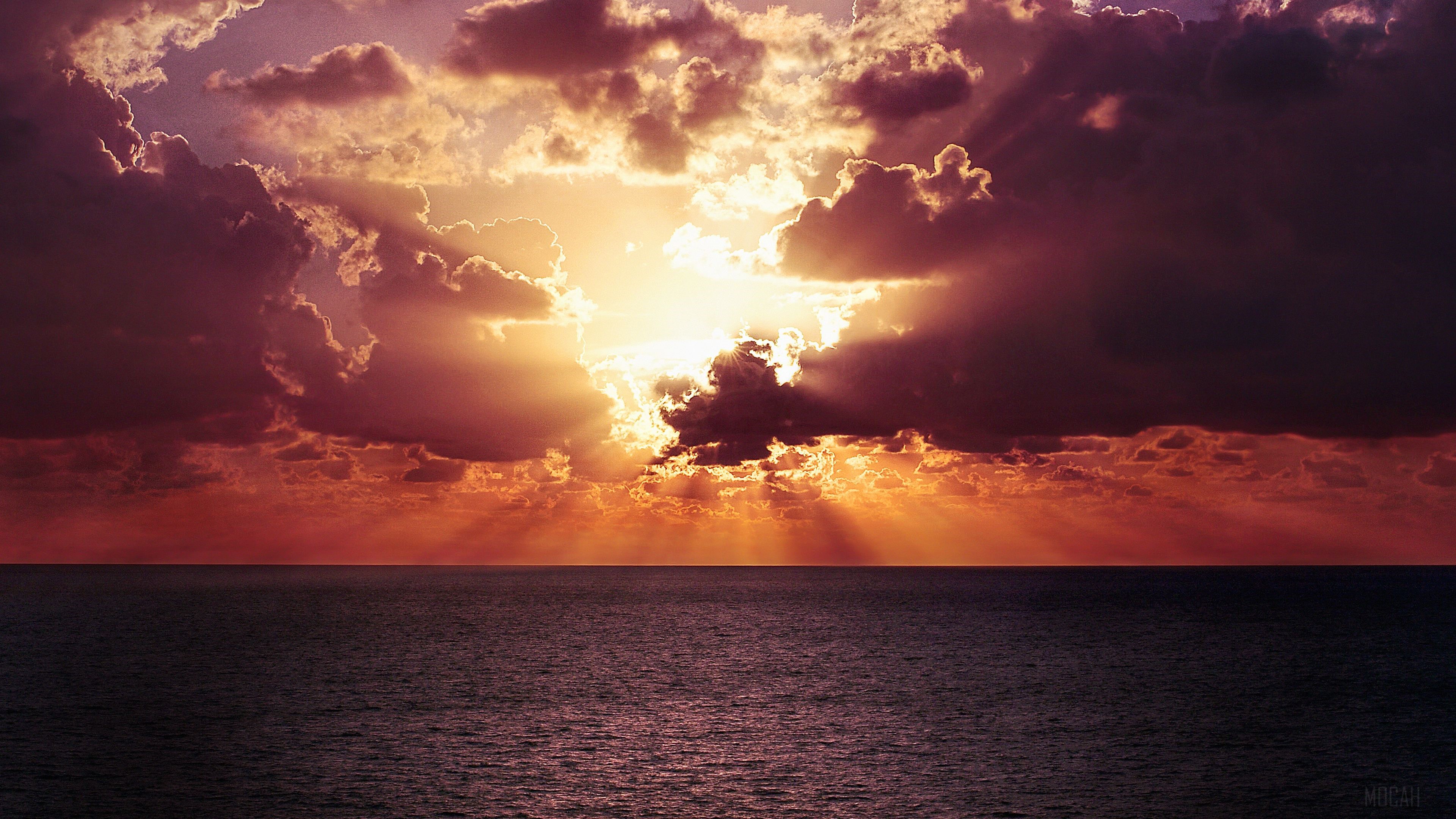 Sunset Over Ocean with Dramatic Clouds 4K HD Wallpaper