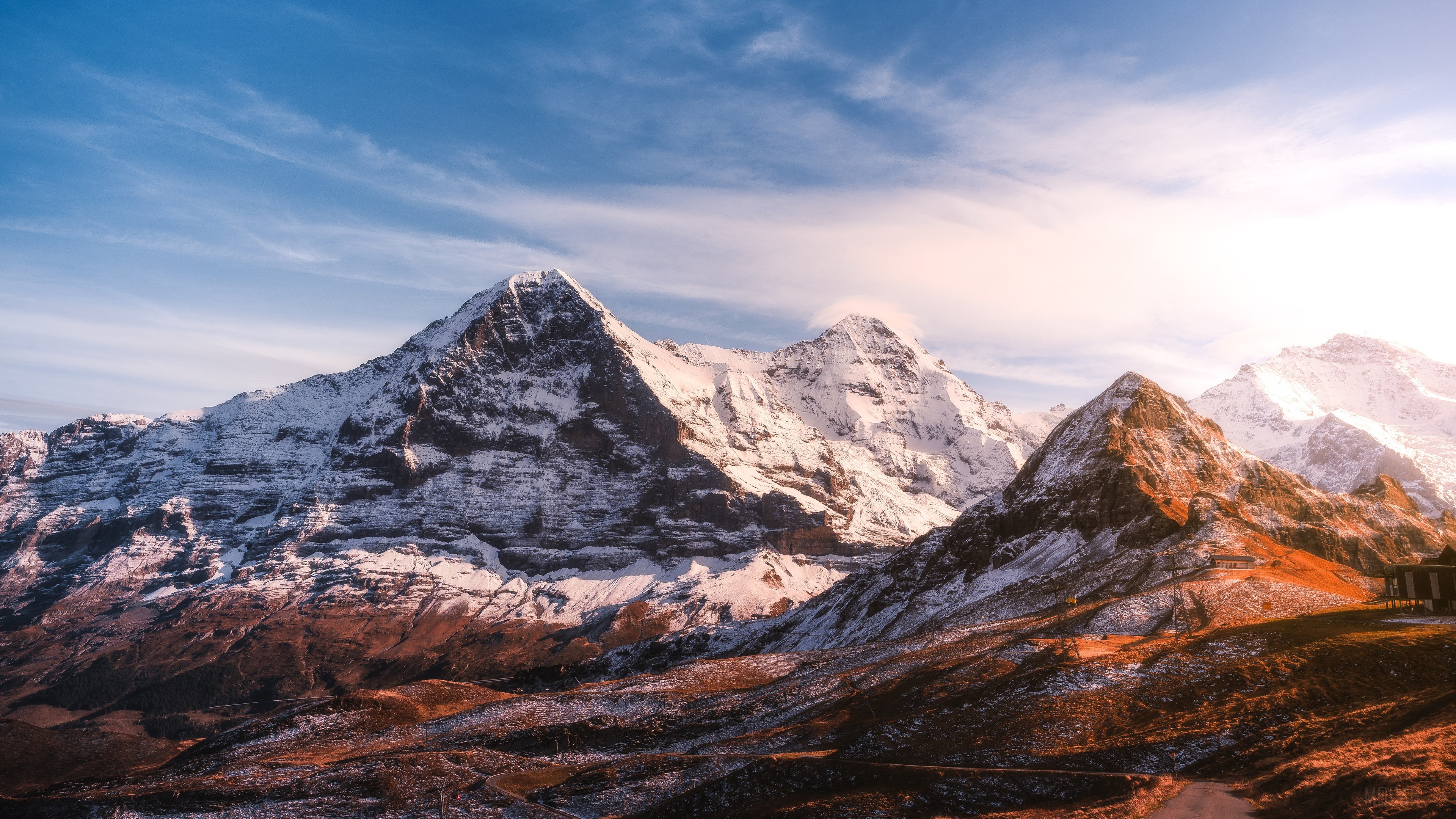 Snow-capped mountains under a blue sky HD Wallpaper