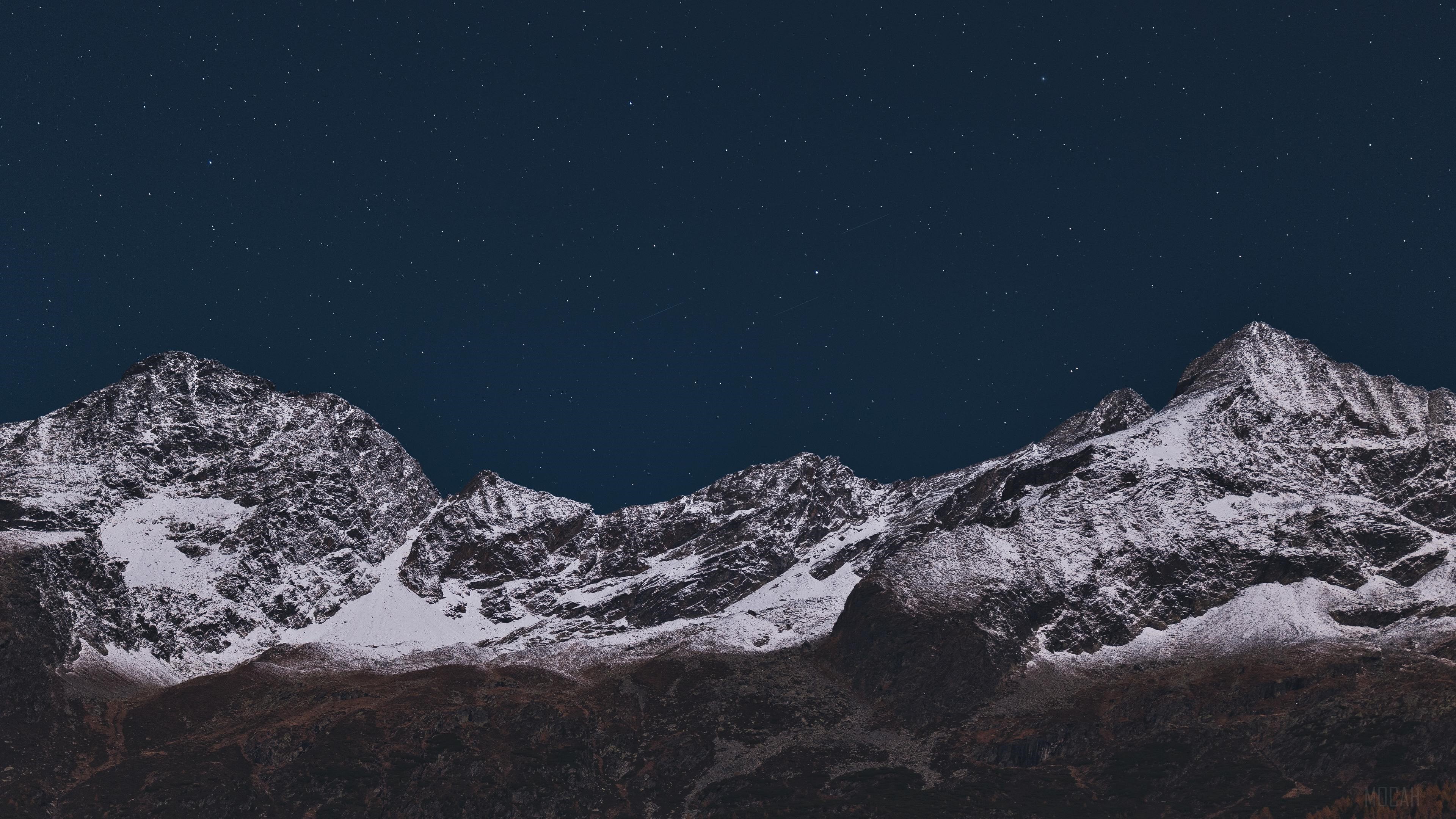 Snow-covered mountains under a starry night sky 4K HD Wallpaper