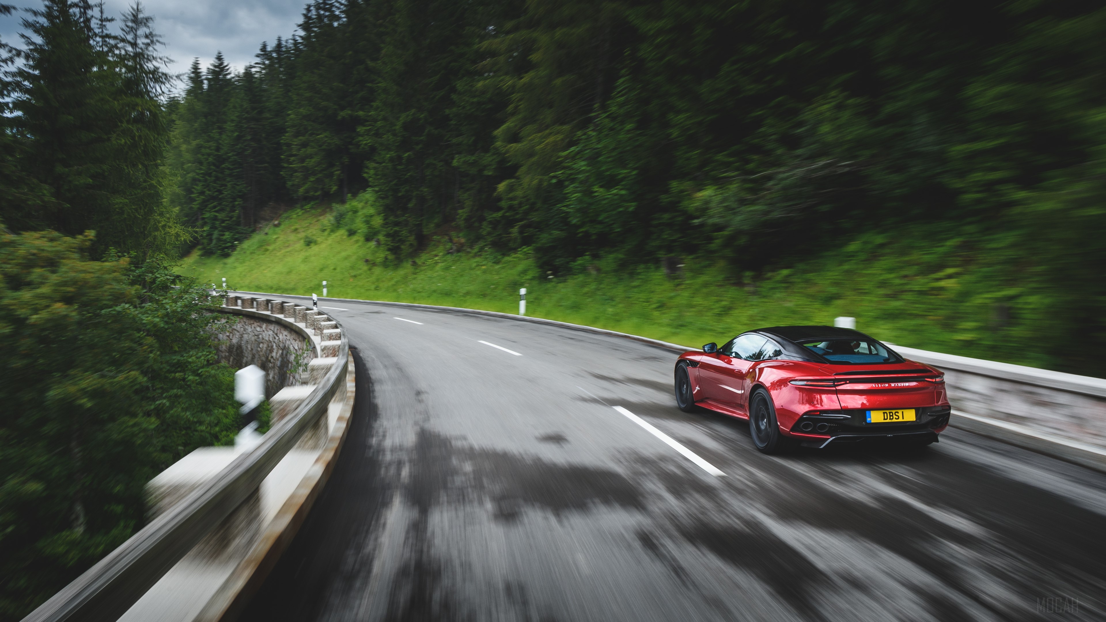 Red Aston Martin DBS Superleggera driving on a mountain road HD Wallpaper