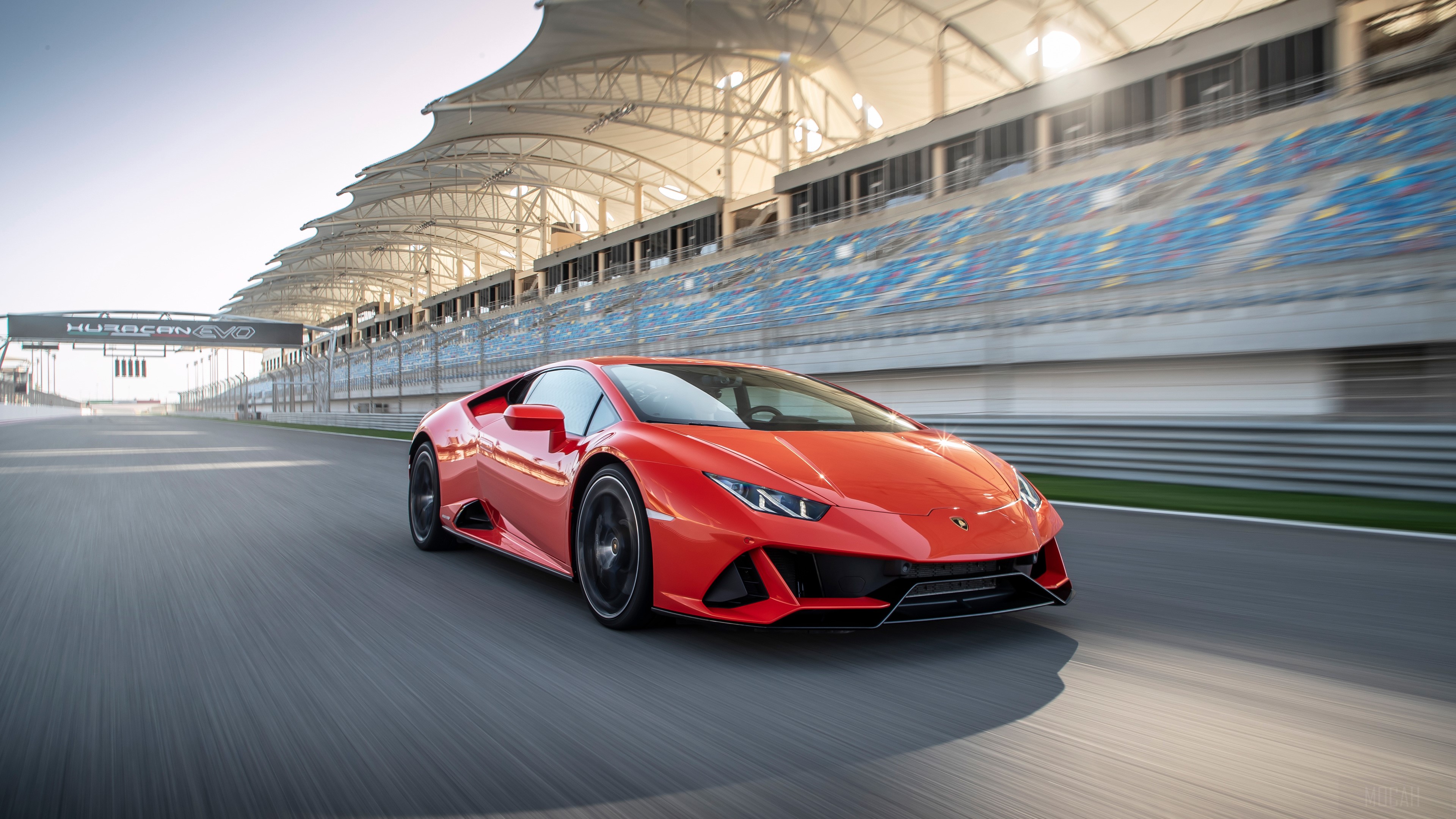 Red Lamborghini Huracan EVO on a race track HD Wallpaper