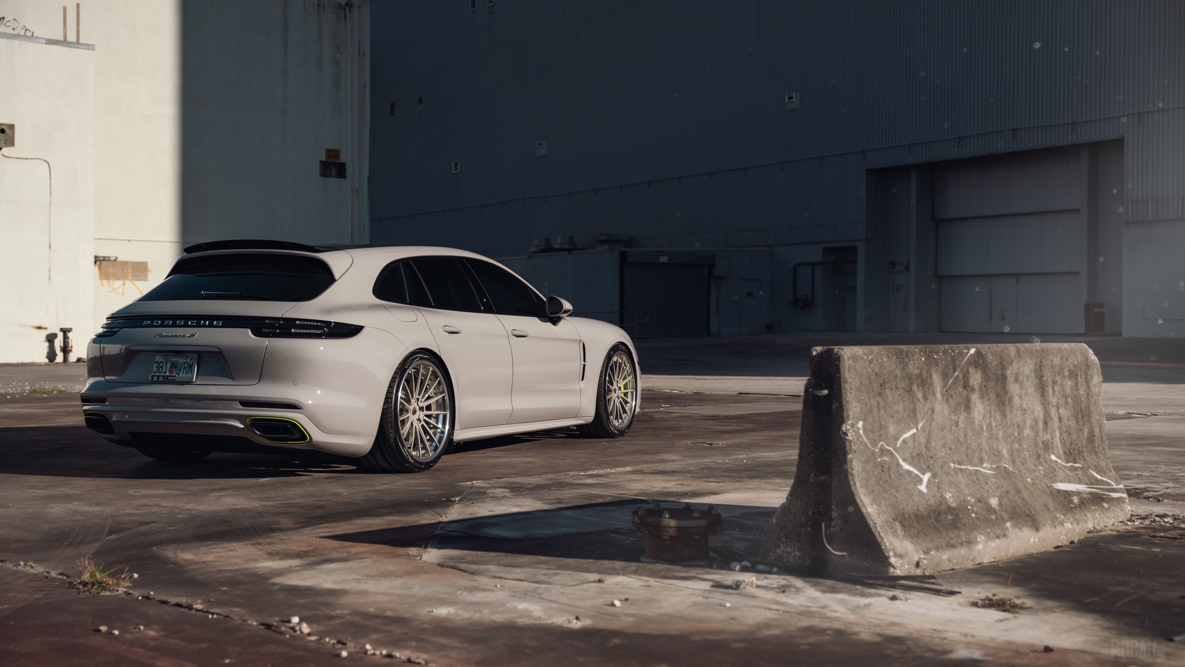 White Porsche Panamera S in industrial area HD Wallpaper