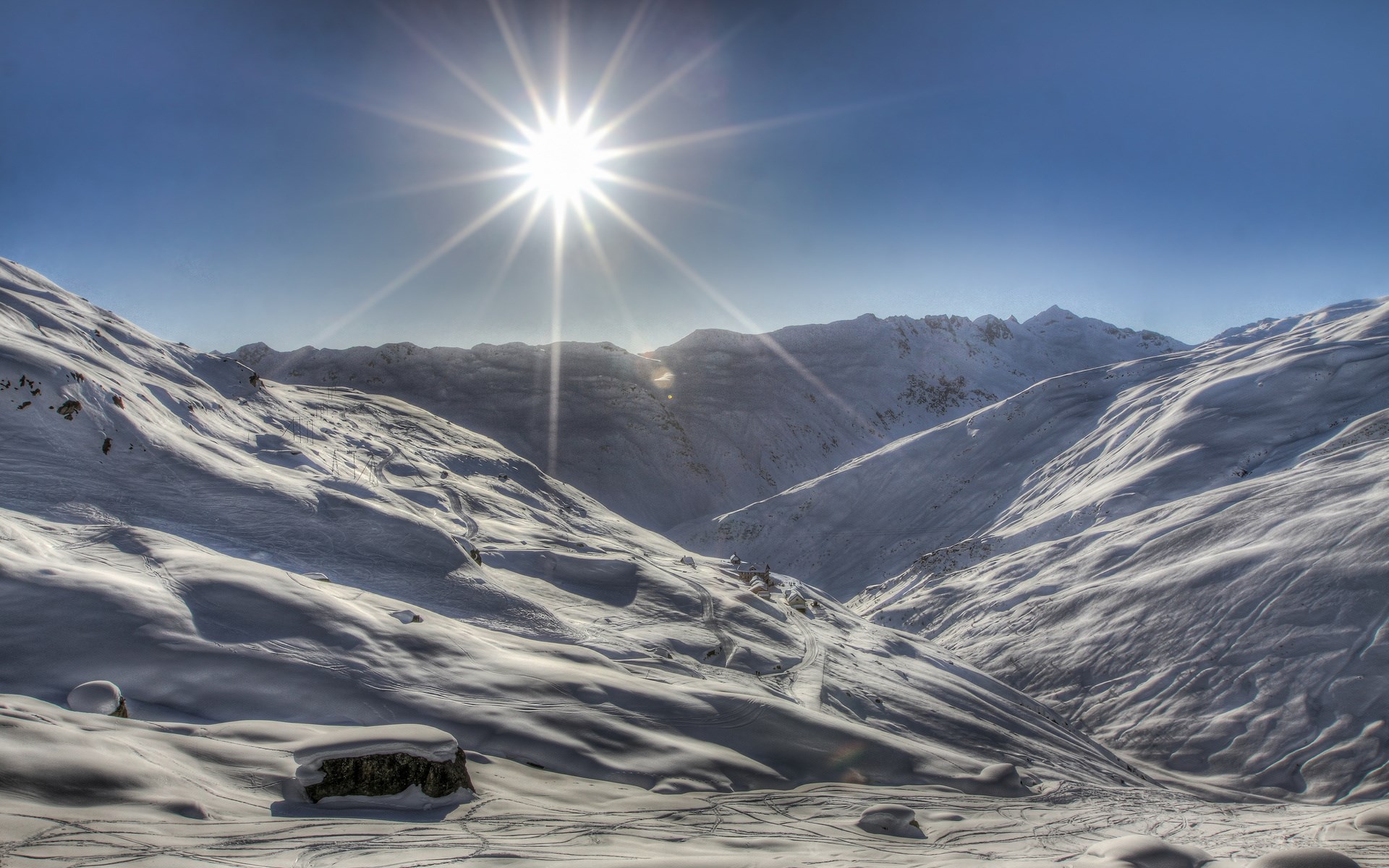 Sun shining over snow-covered mountains HD Wallpaper