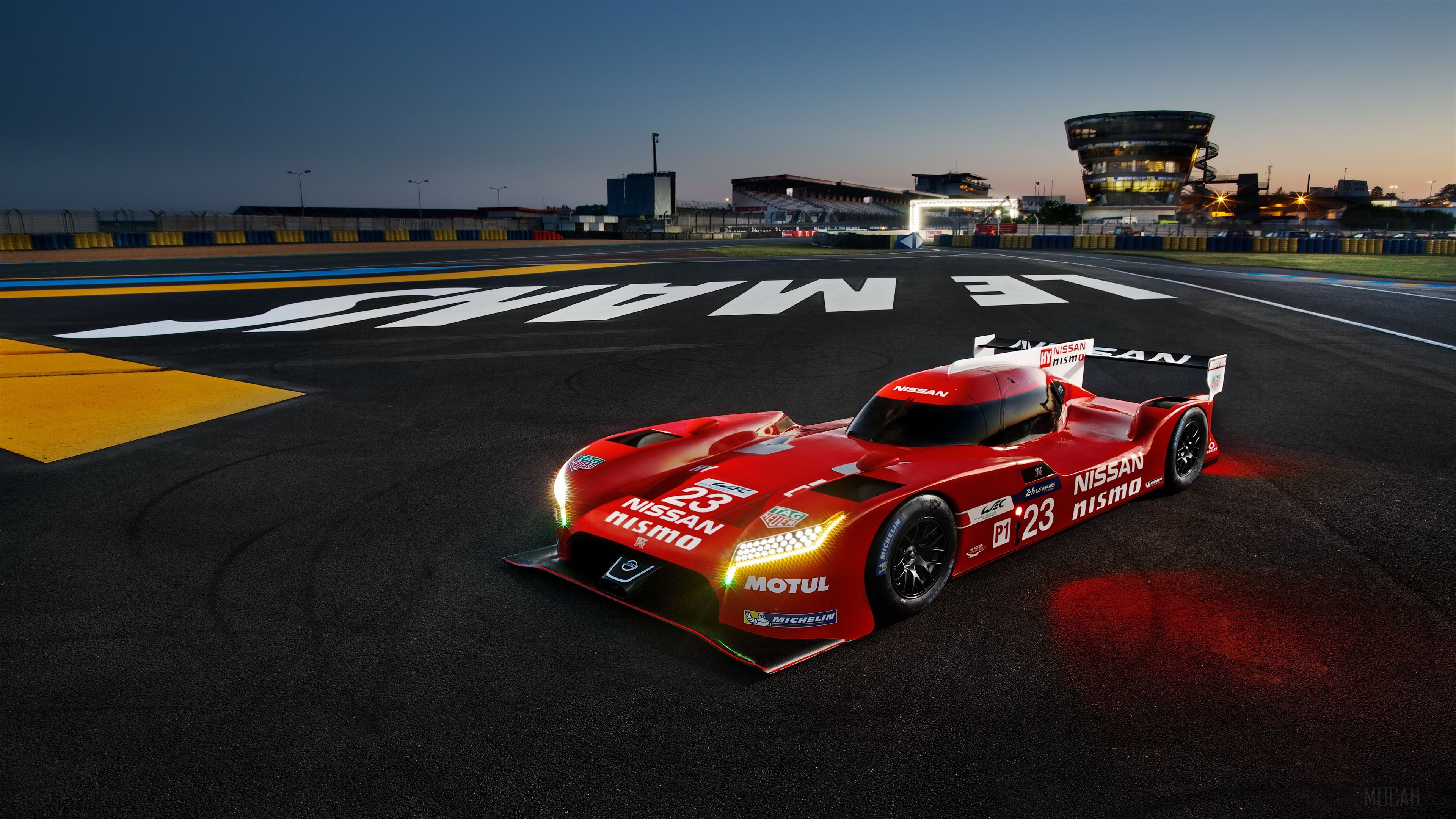 Red Nissan GT-R Nismo race car on Le Mans track HD Wallpaper