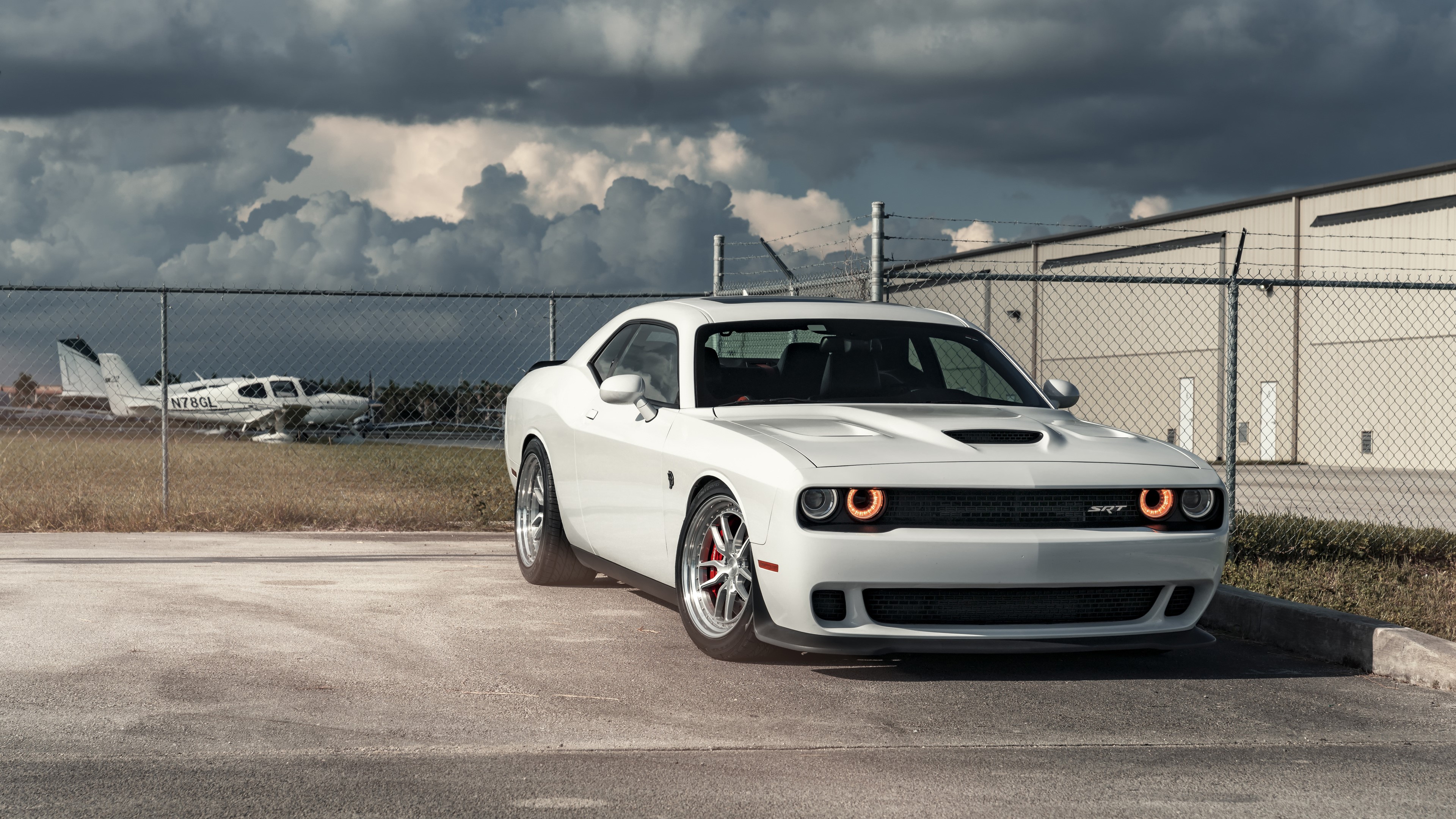 White Dodge Hellcat SRT parked near airplane HD Wallpaper