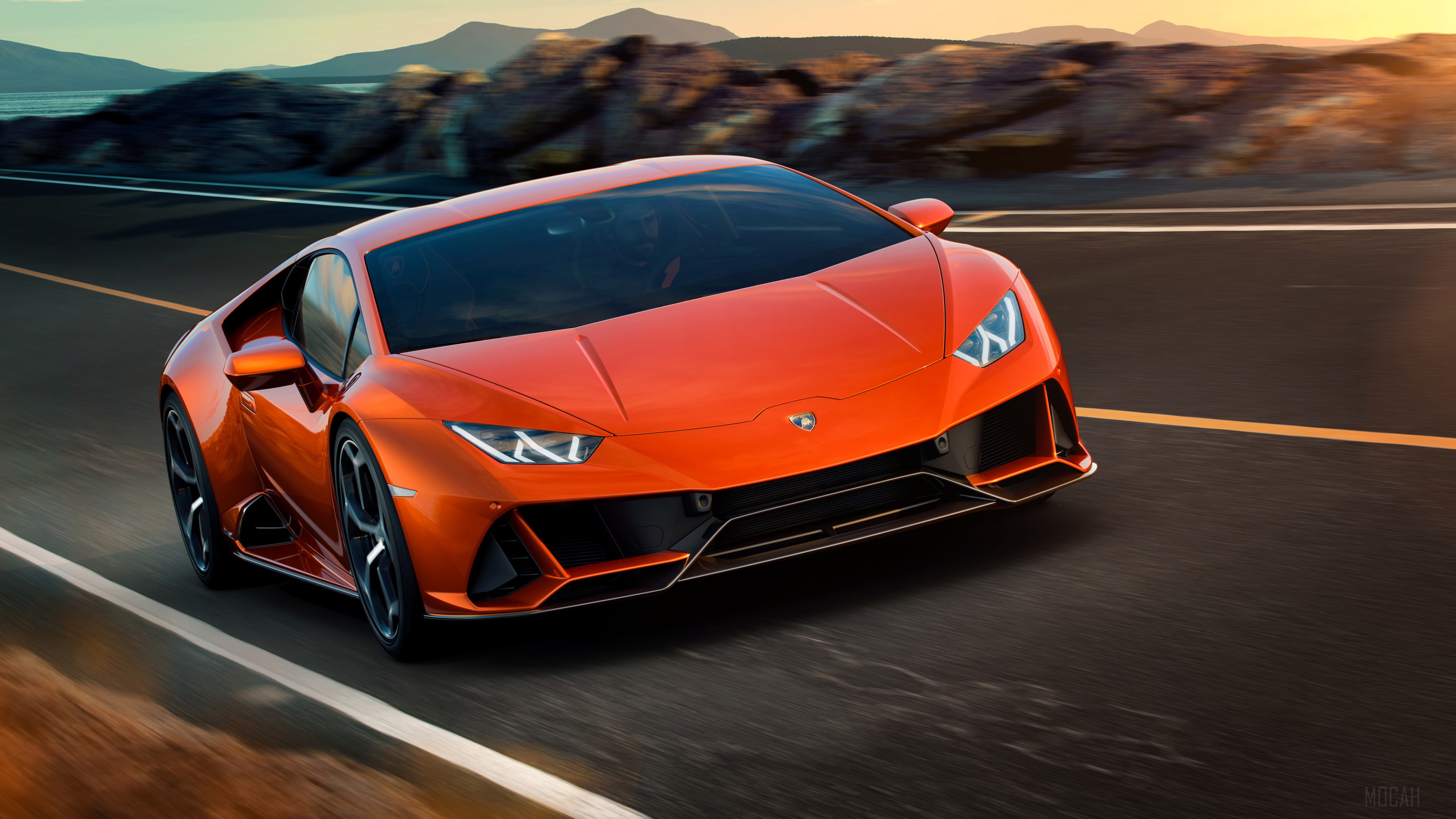 Orange Lamborghini Huracan EVO driving on a road HD Wallpaper
