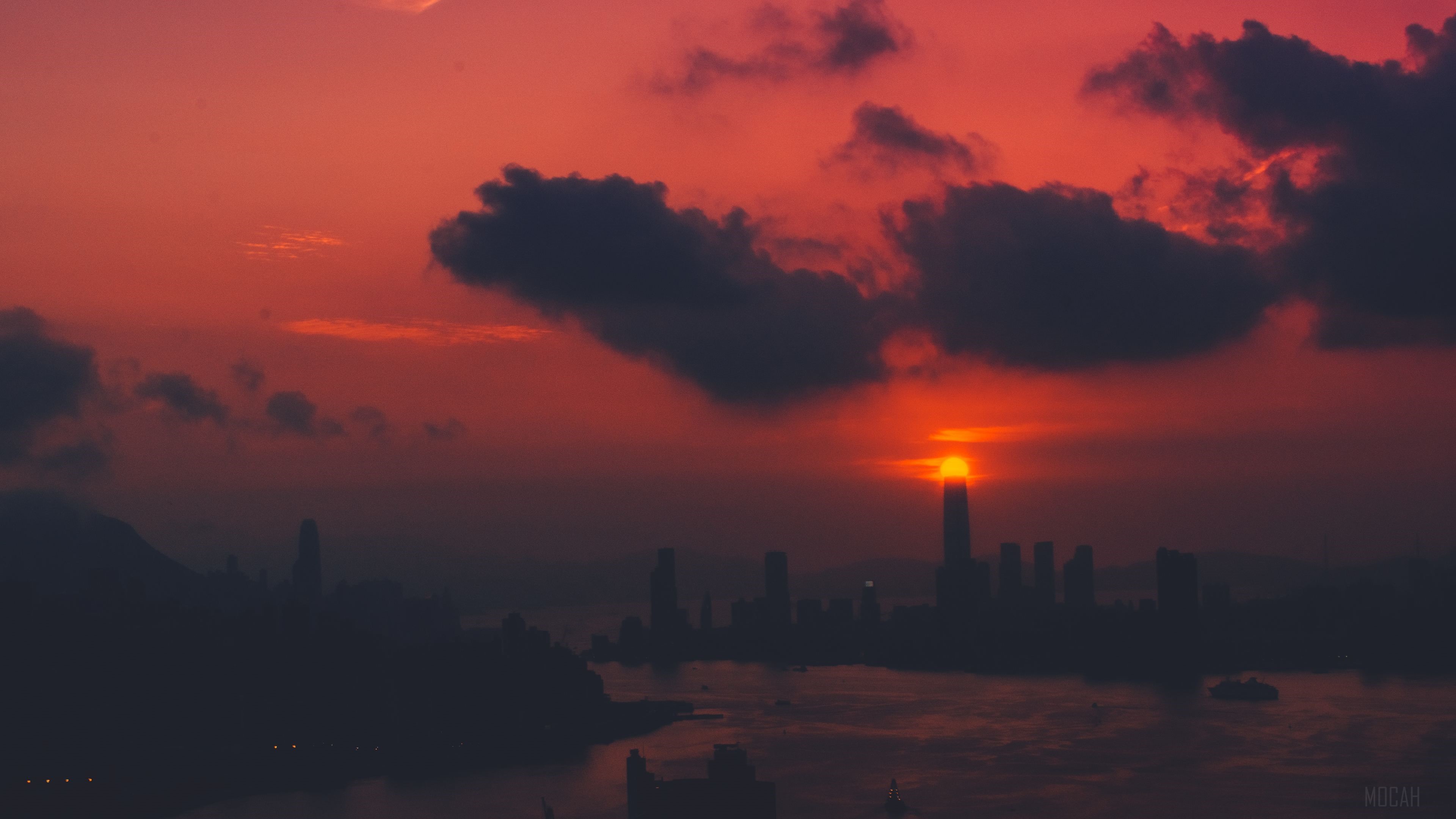 Sunset over a city skyline with clouds HD Wallpaper