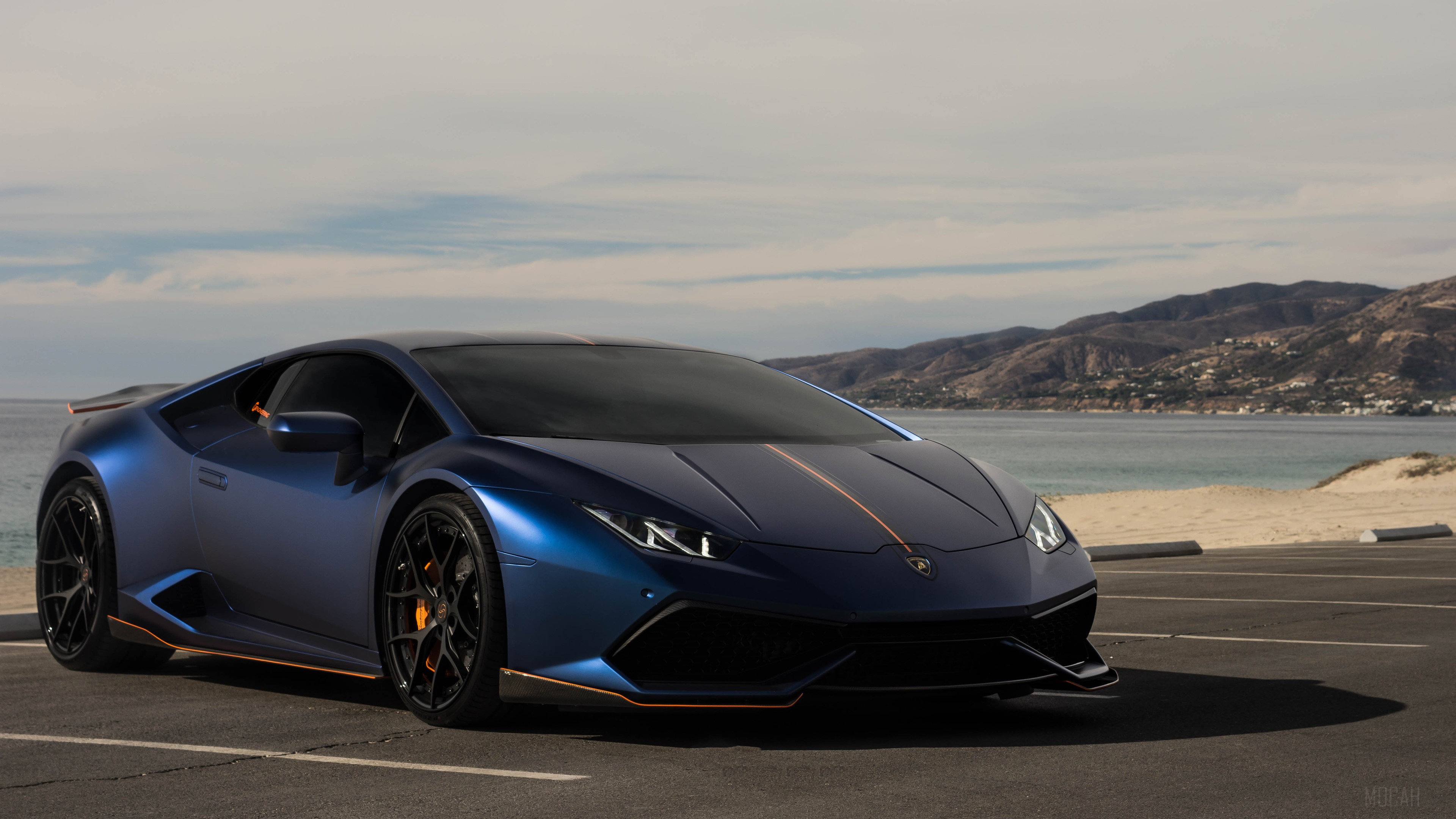 Blue Lamborghini Huracan parked by the ocean HD Wallpaper