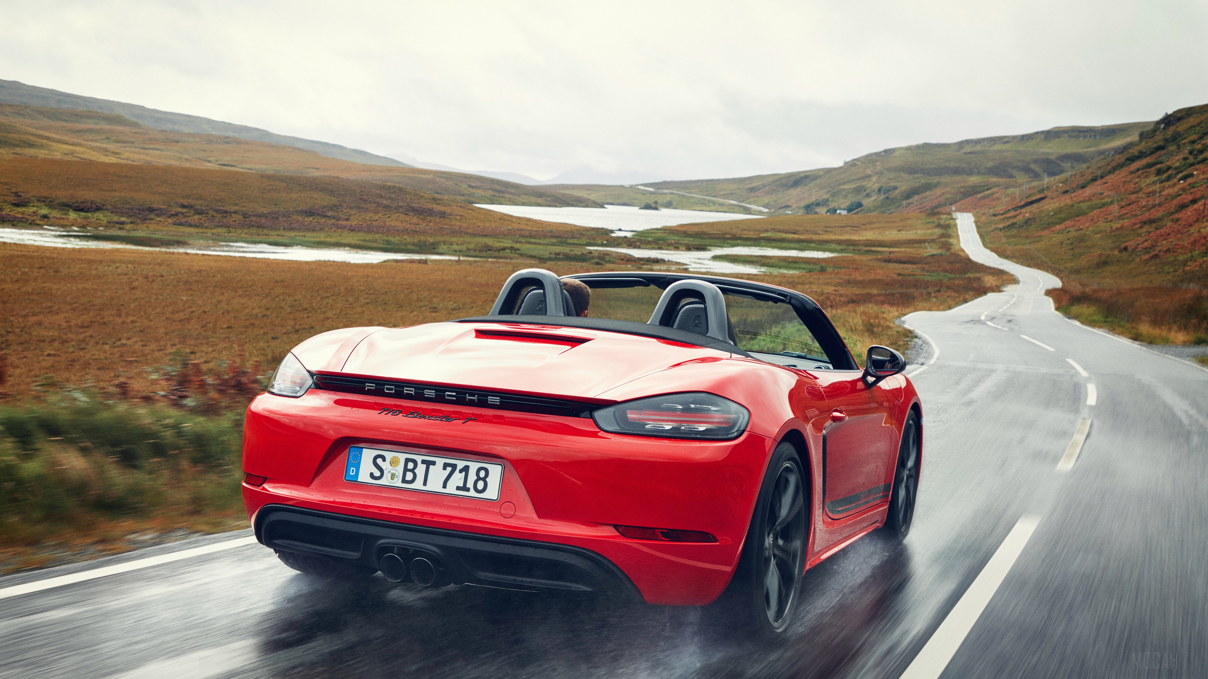 Red Porsche 718 Boxster driving on a wet road HD Wallpaper