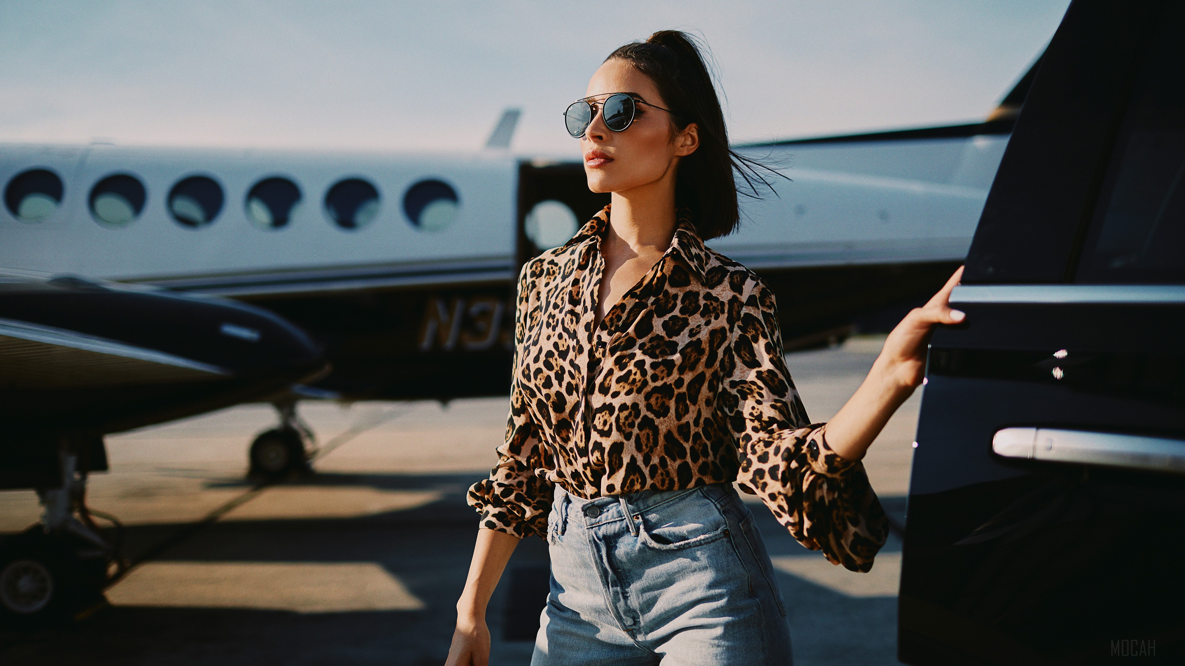 Olivia Culpo on a tarmac with a private jet HD Wallpaper