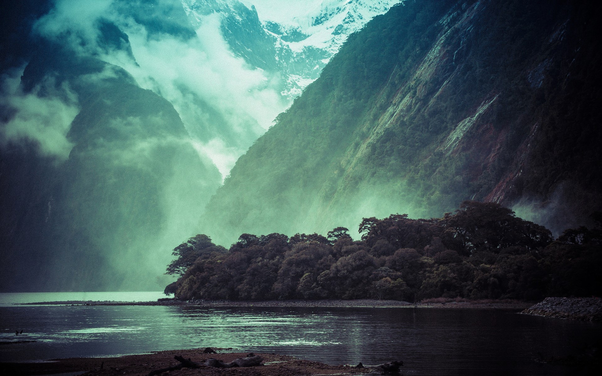 Misty mountains and a dark forest by the water HD Wallpaper