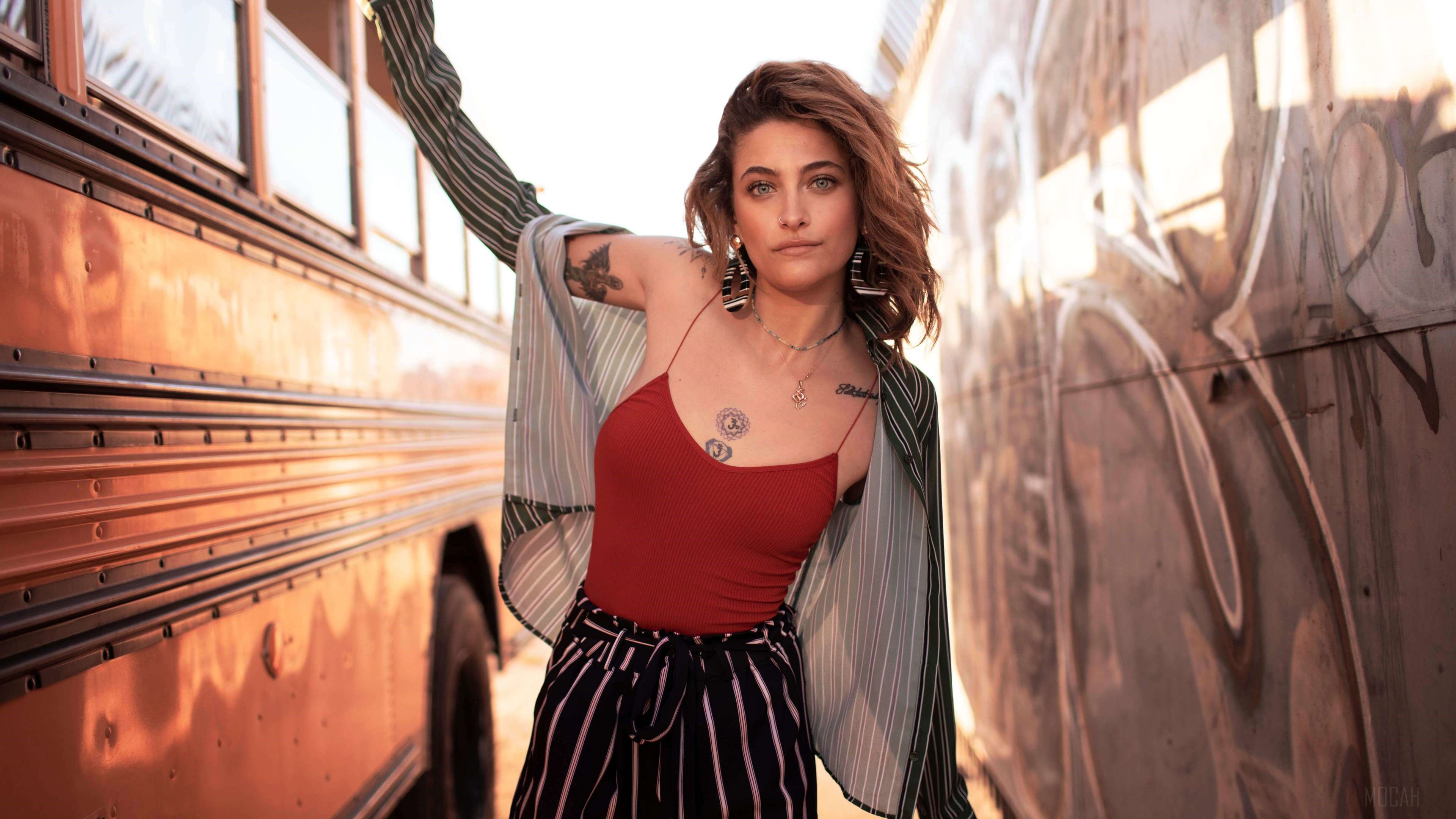 Paris Jackson posing between a bus and graffiti wall HD Wallpaper