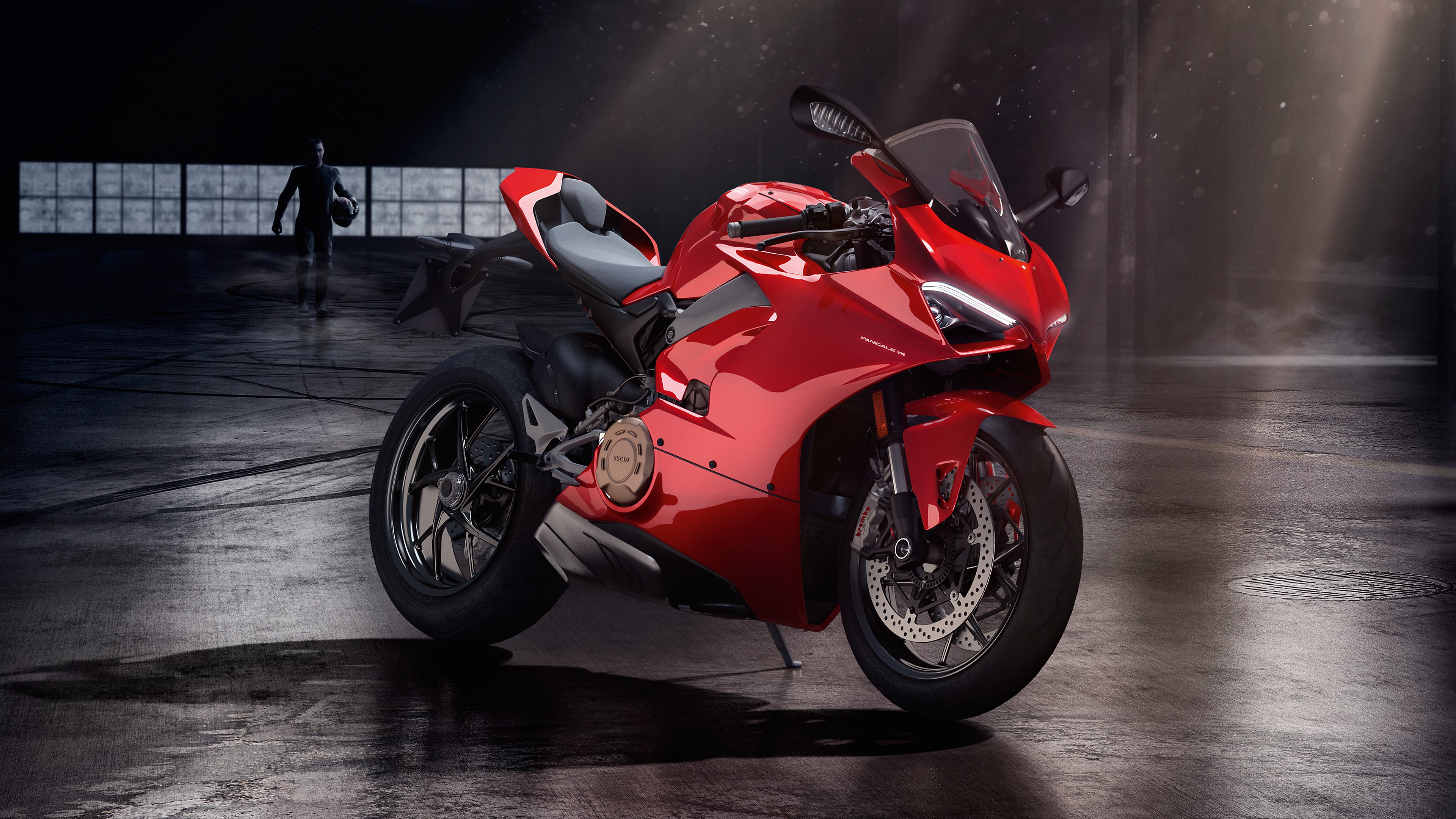 Red Ducati motorcycle in a dark garage HD Wallpaper