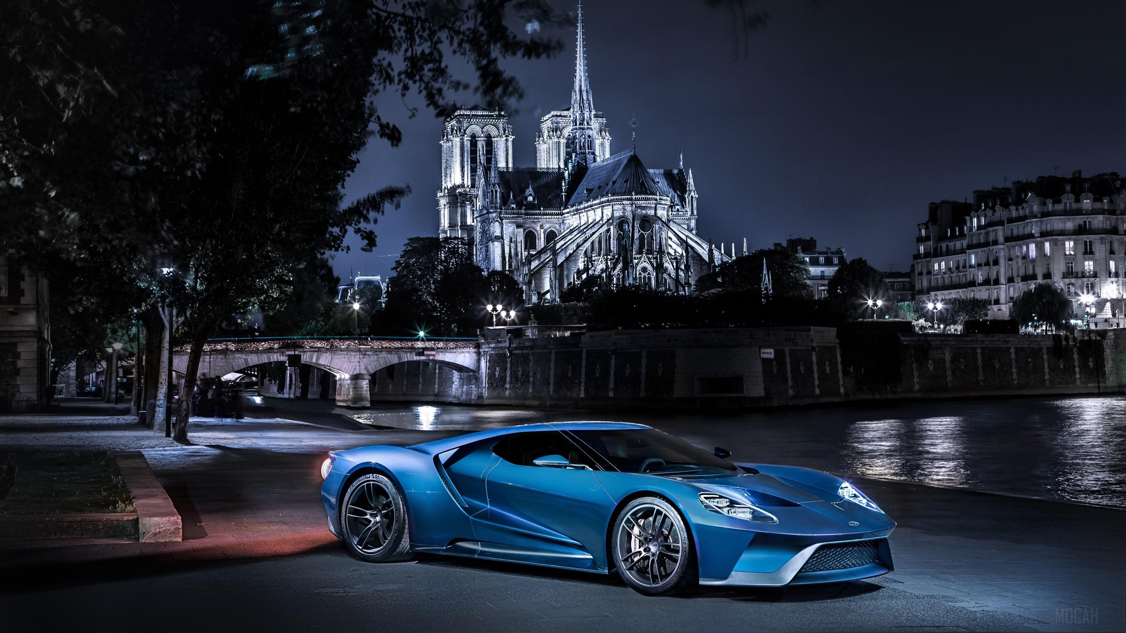 Blue Ford GT parked by Notre Dame at night HD Wallpaper