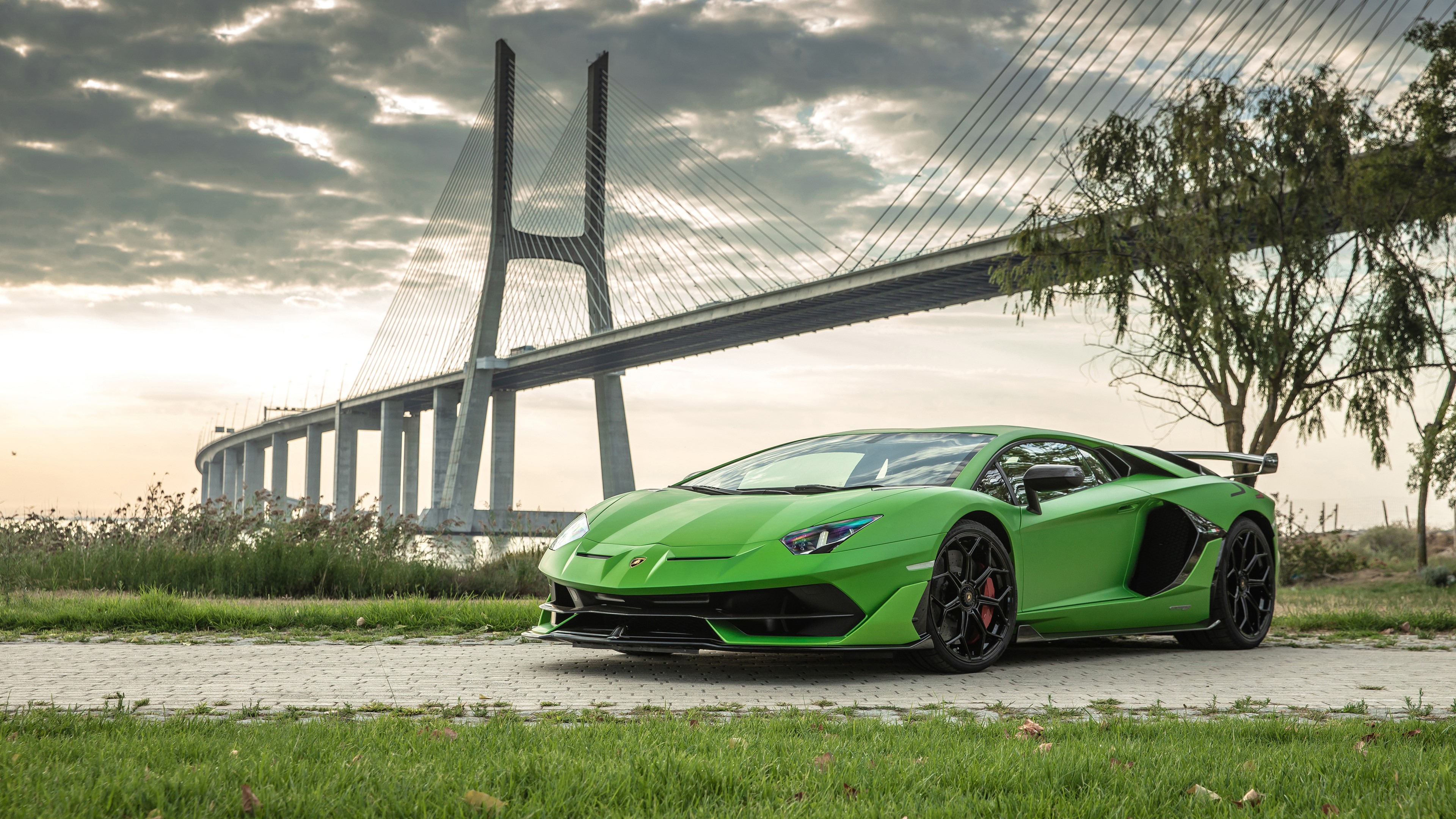 Green Lamborghini Aventador SVJ 2019 parked near a bridge HD Wallpaper