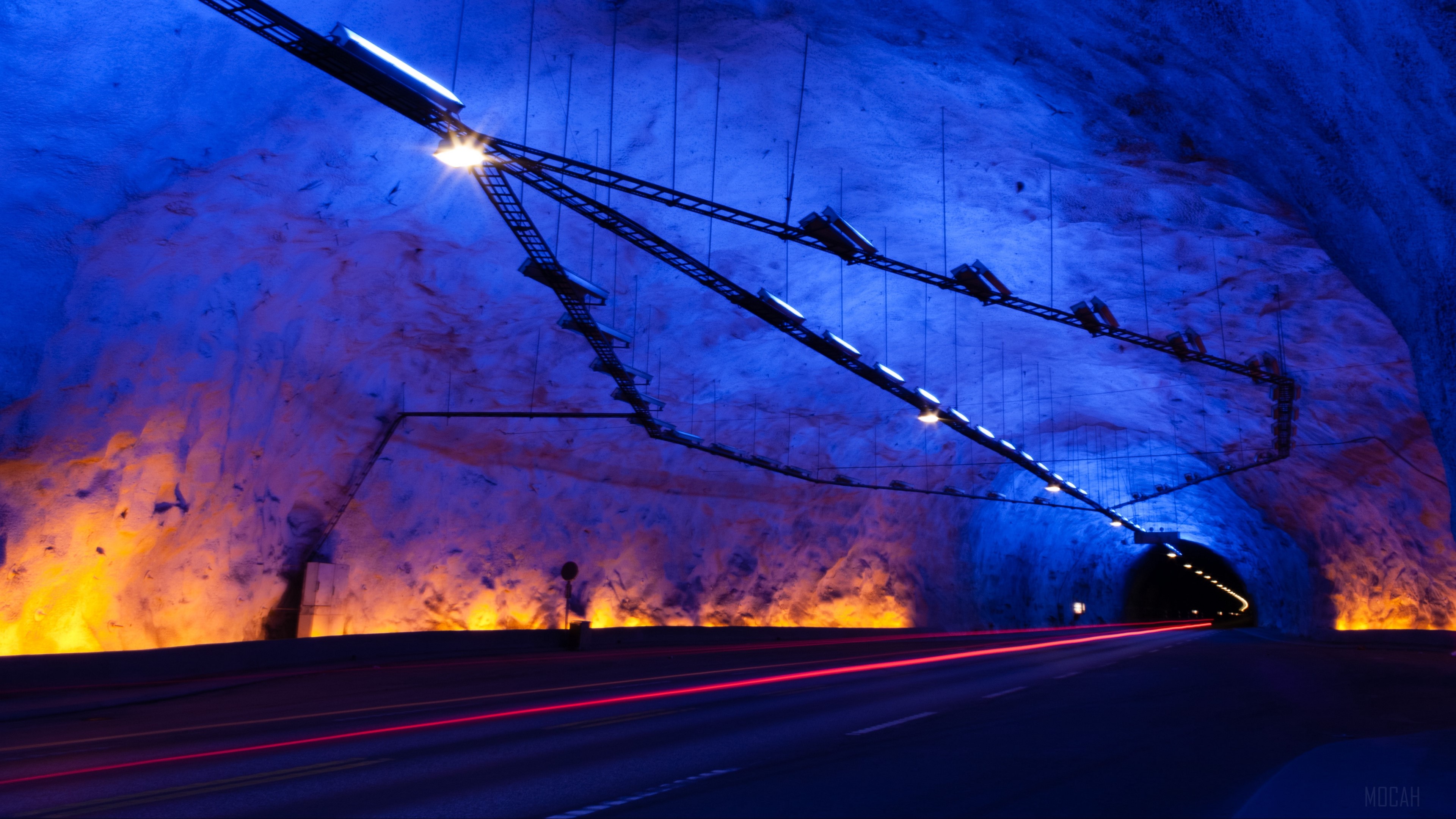 Tunnel with blue and orange lighting and light trails HD Wallpaper