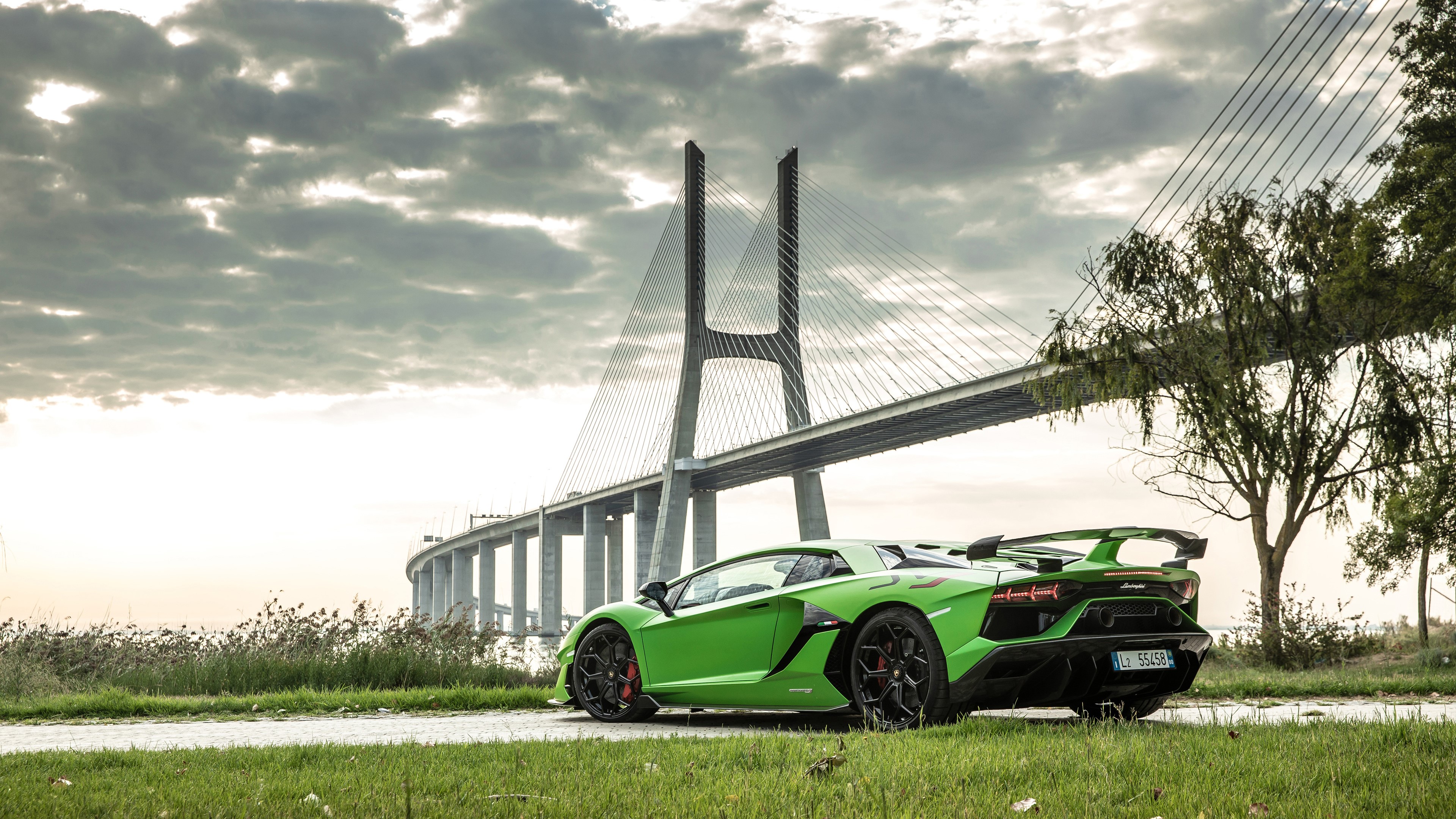 Green Lamborghini Aventador SVJ 2019 near Vasco da Gama Bridge HD Wallpaper