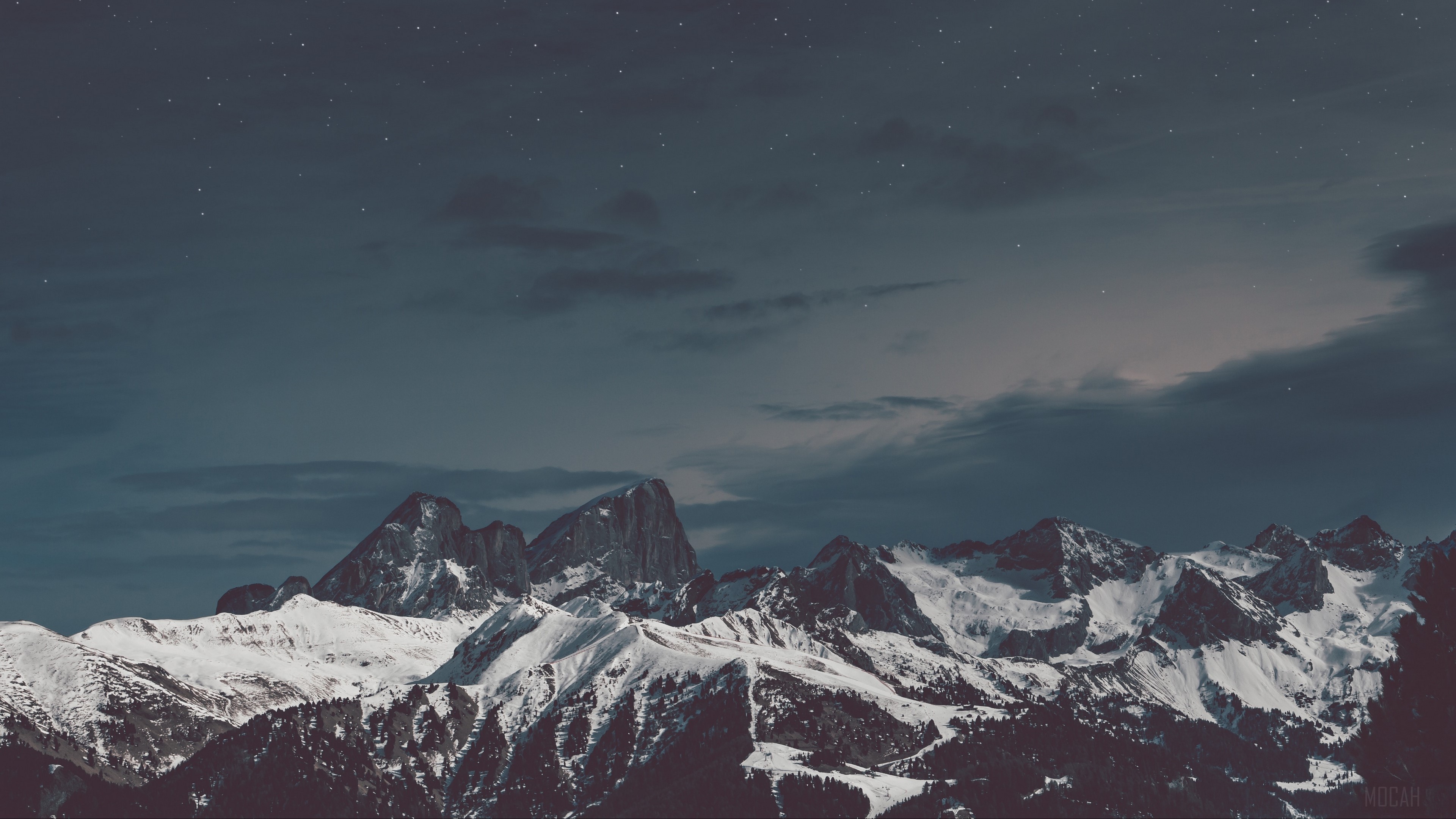 Snow-capped mountains under a starry night sky HD Wallpaper