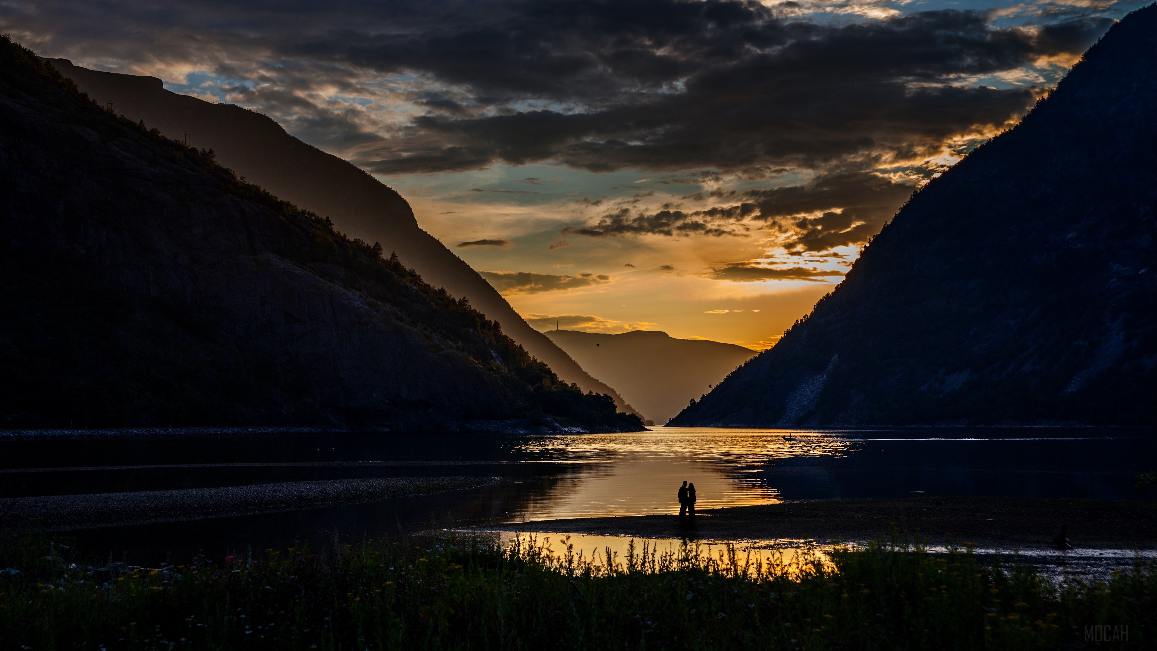 Couple silhouetted by sunset in Norwegian fjord mountains 4K HD Wallpaper