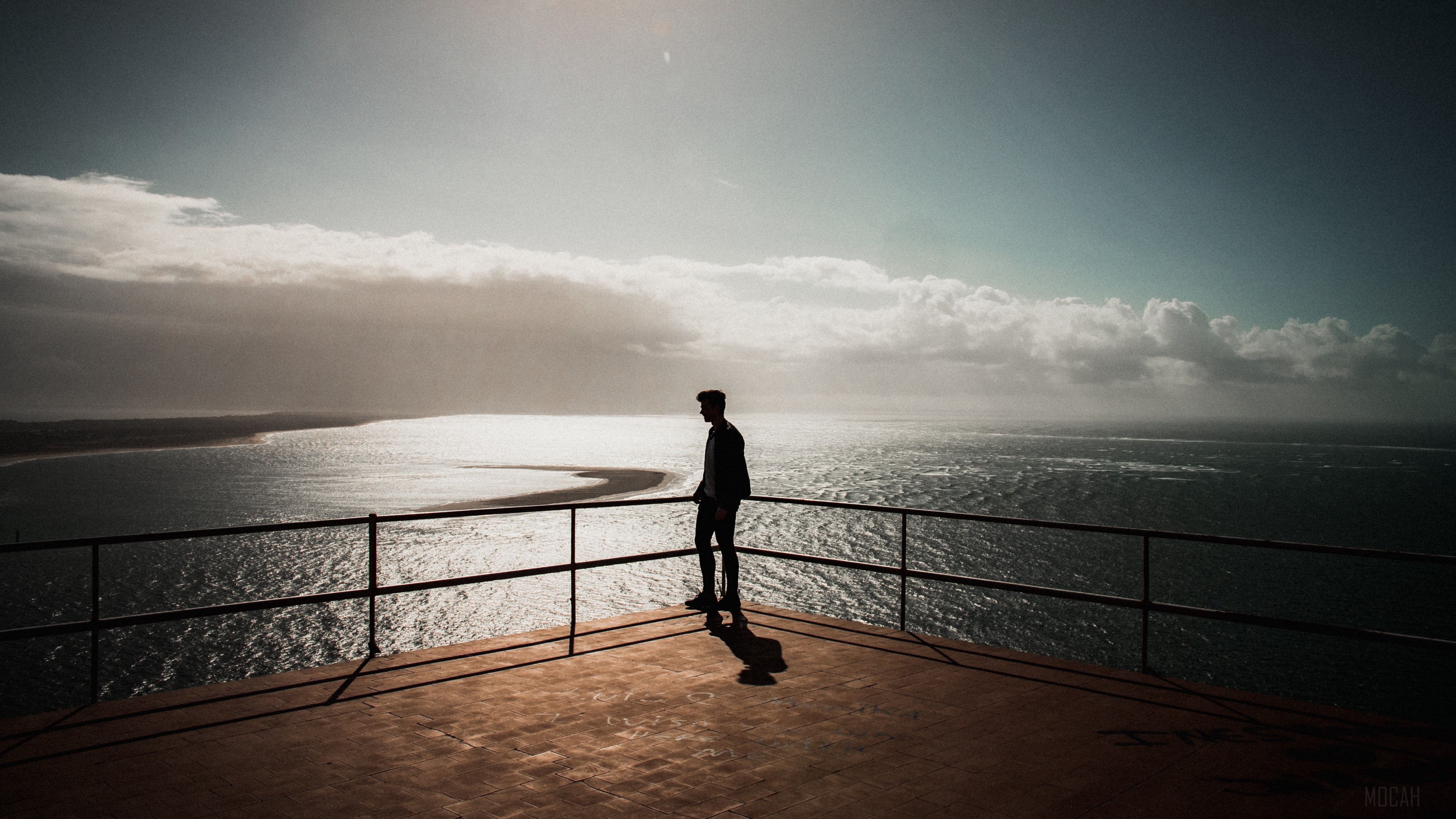 Silhouette of a man overlooking the sea in Setubal, Portugal 4K HD Wallpaper