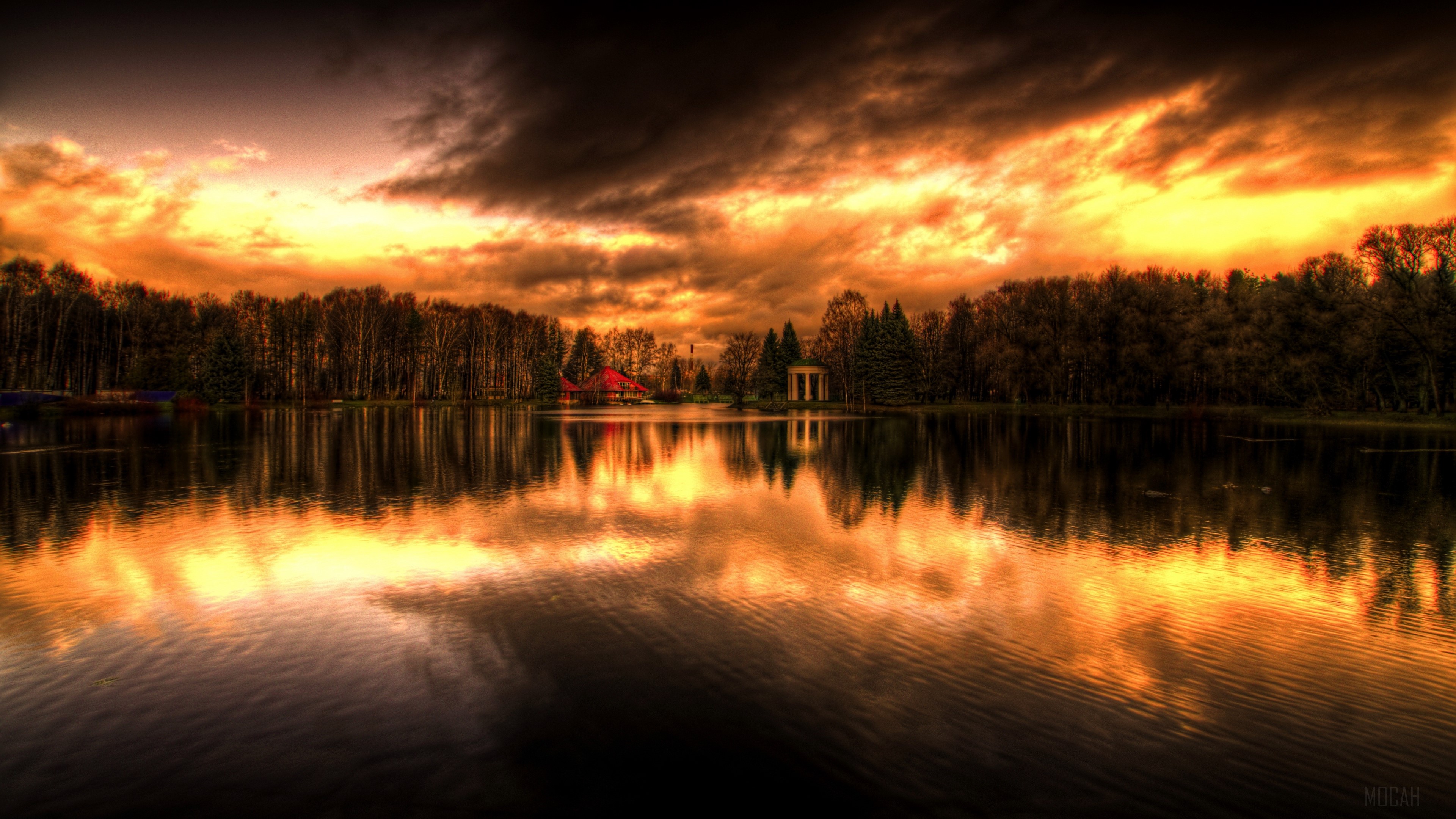 Sunset over a lake with trees and buildings HD Wallpaper