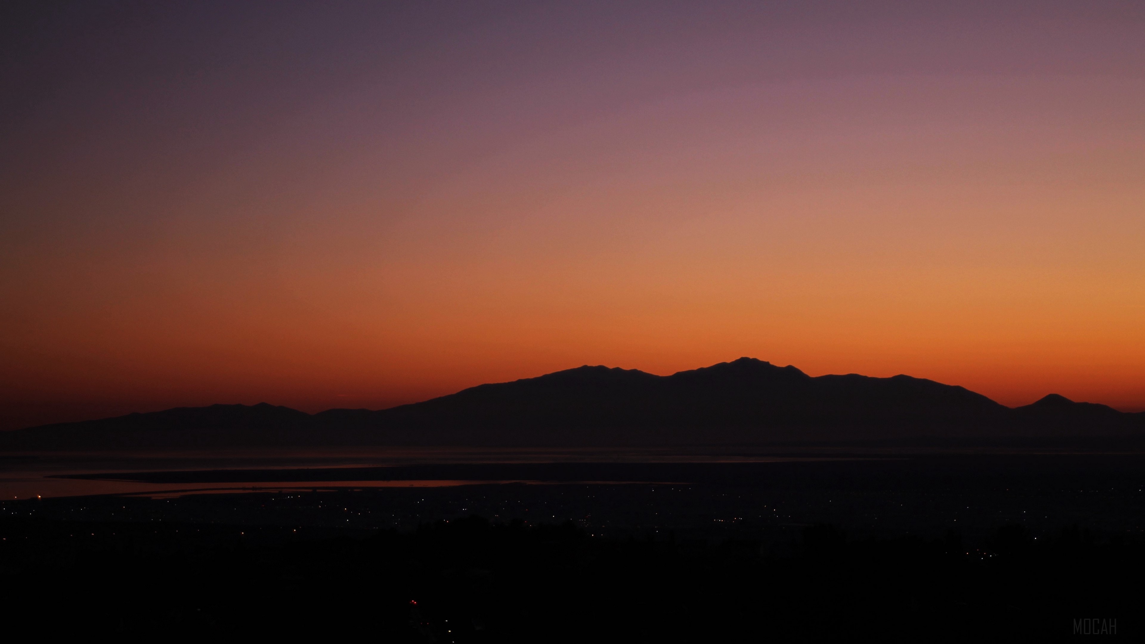Mountains and city lights at sunset 4K HD Wallpaper