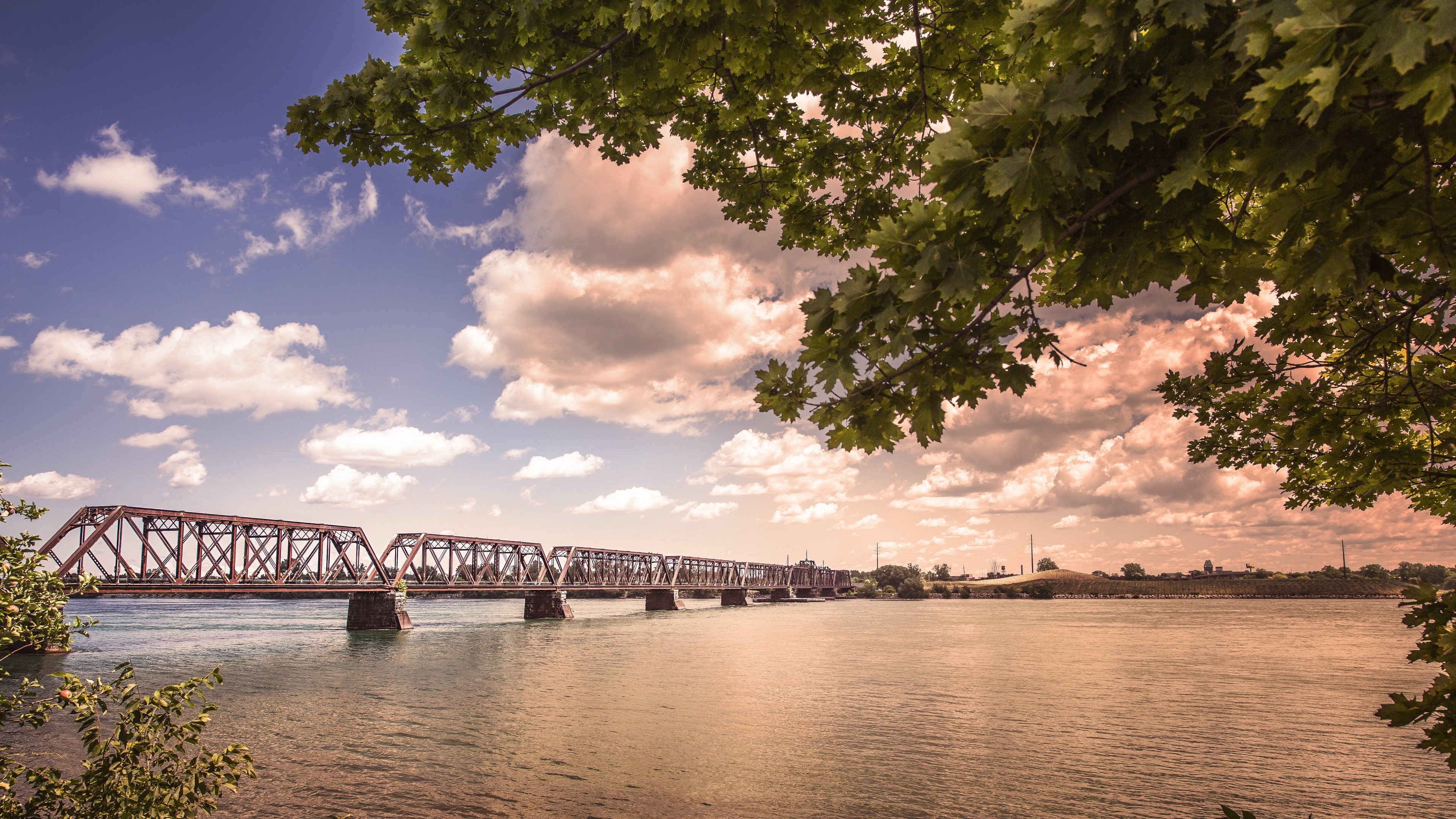 Train bridge over a river with trees and clouds 4K HD Wallpaper