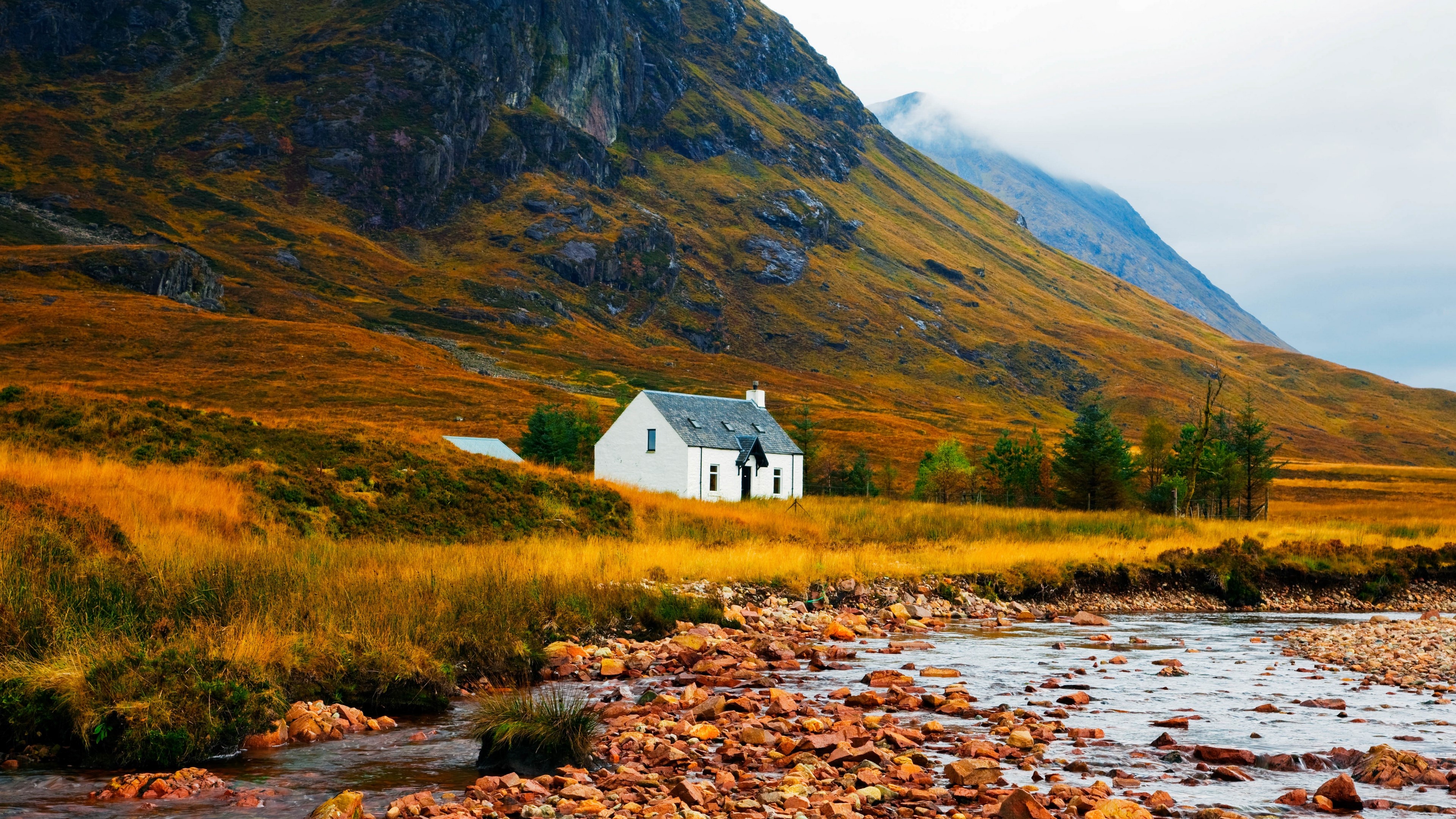 White house in mountains with river and stones 4K HD Wallpaper