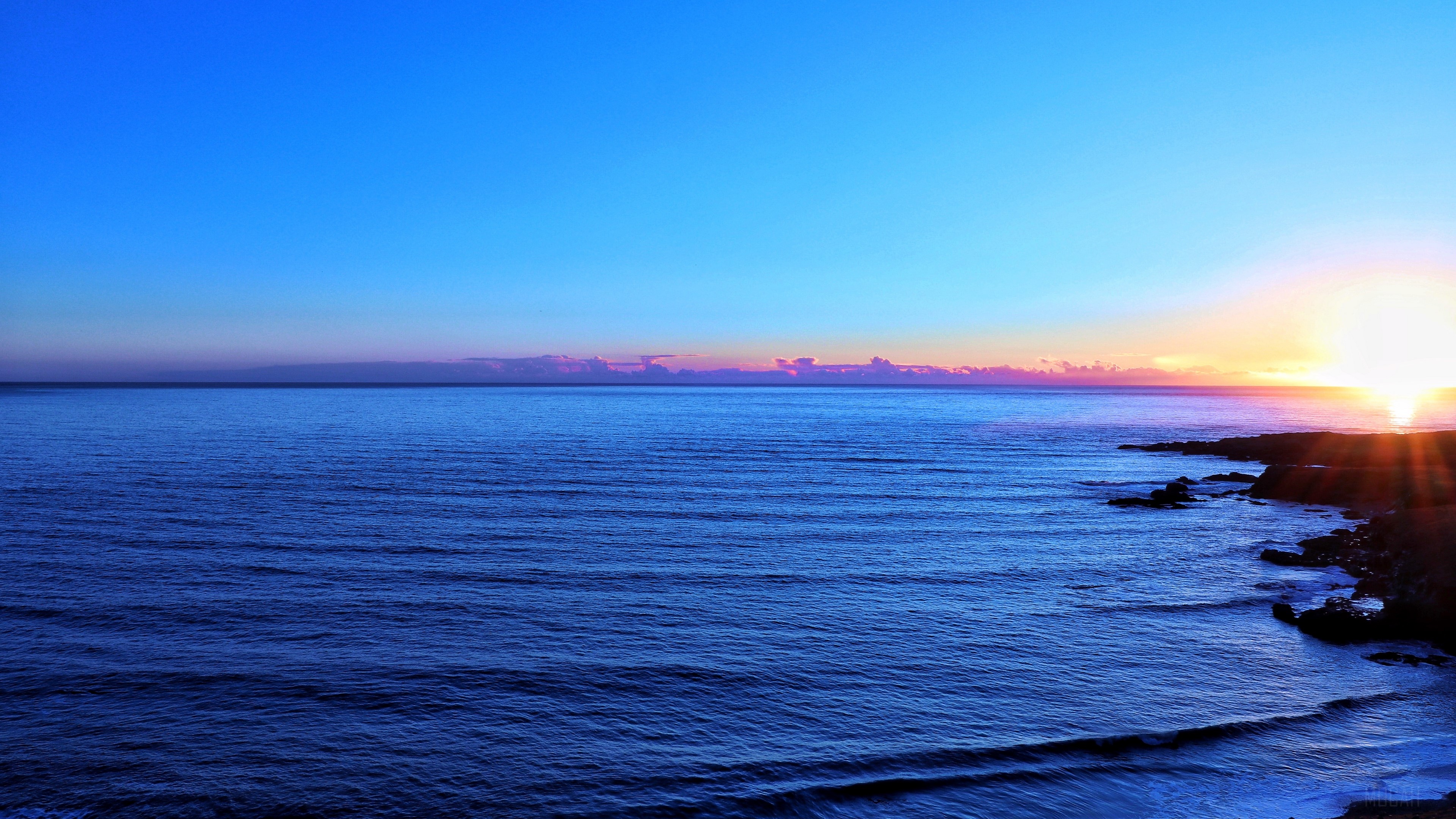 Ocean and rocky coastline at sunset 4K HD Wallpaper