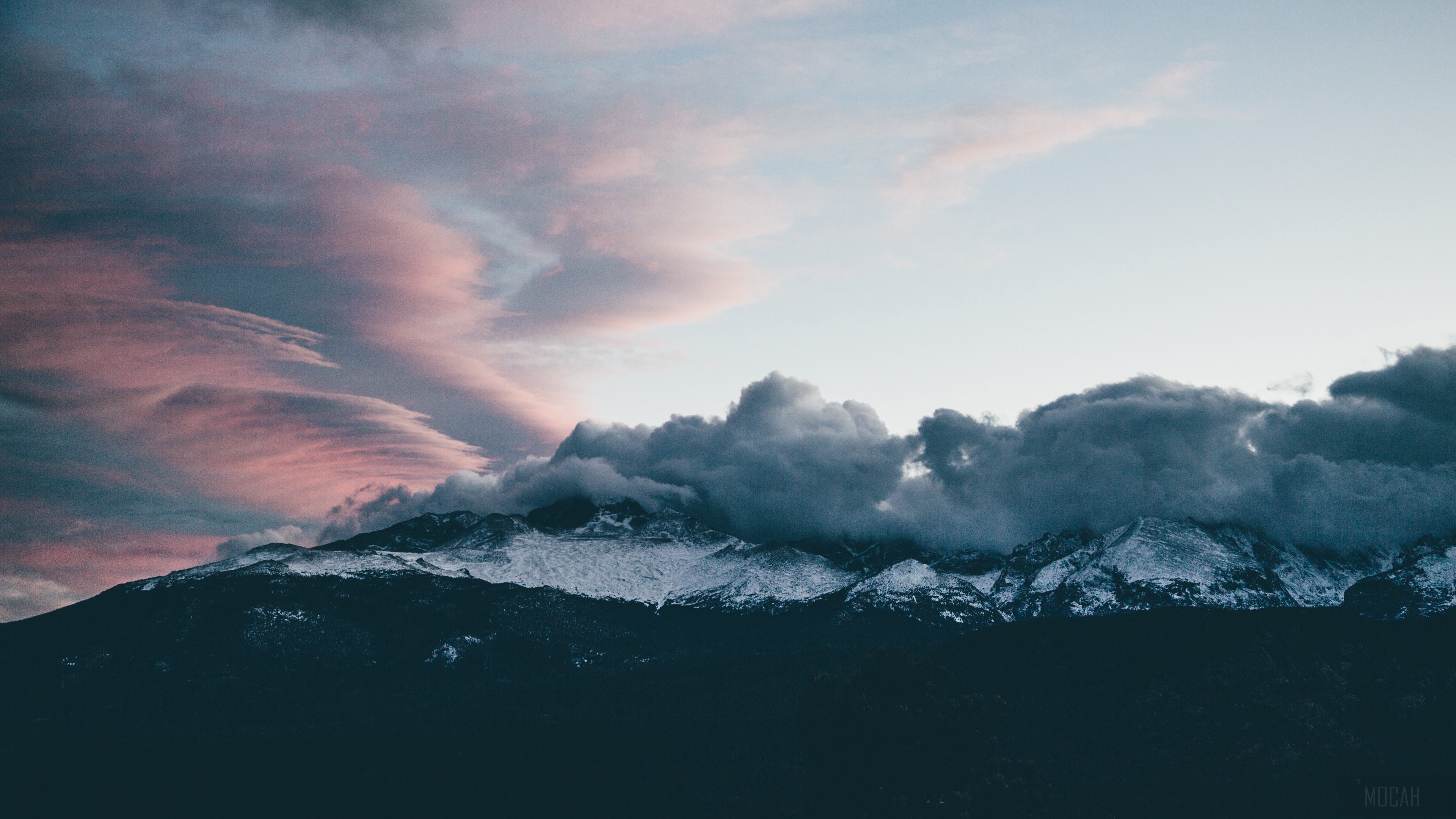 Snow-capped mountains under pink and grey clouds HD Wallpaper