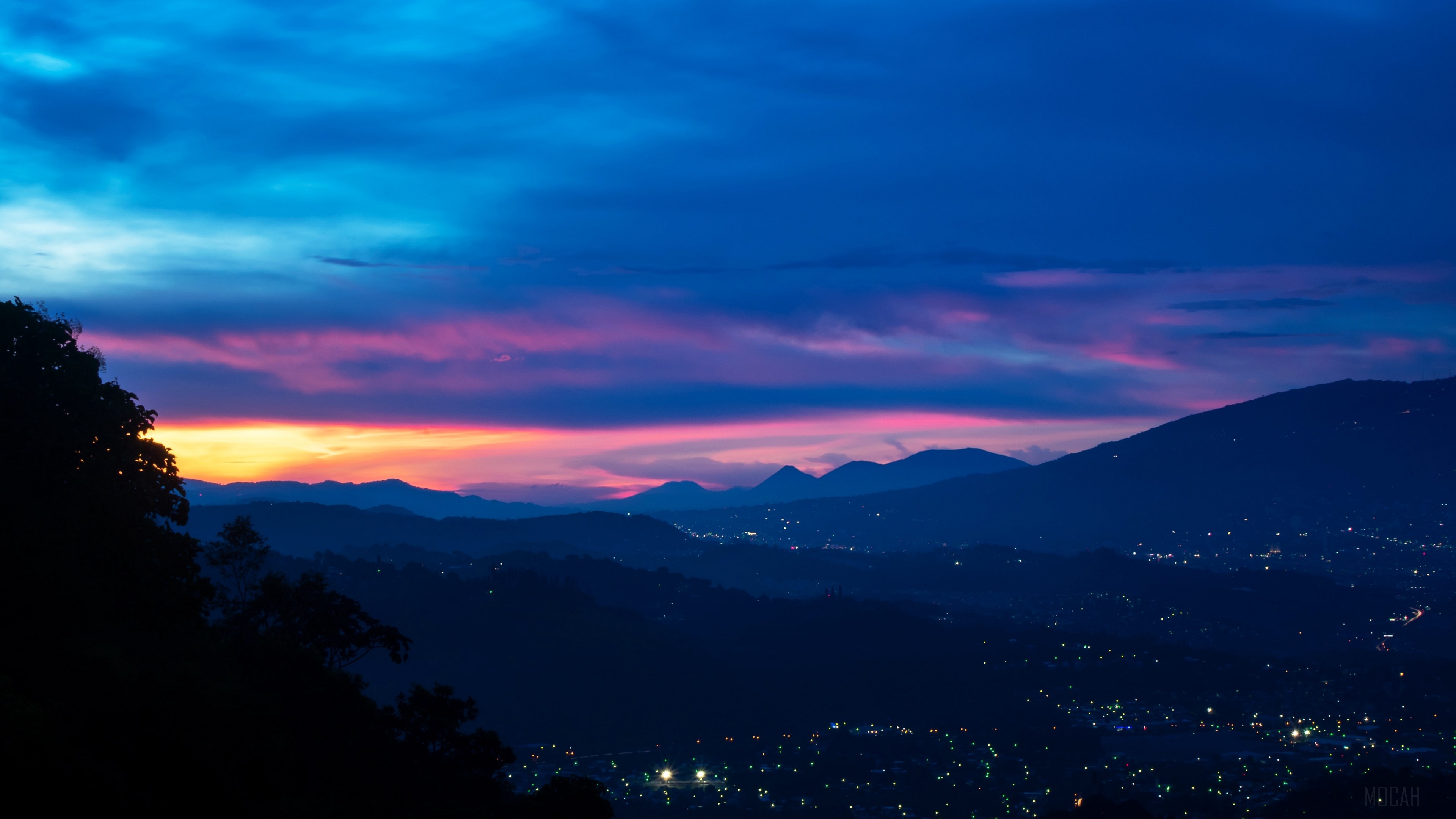 Mountains and city lights at dusk with colorful sky 4K HD Wallpaper