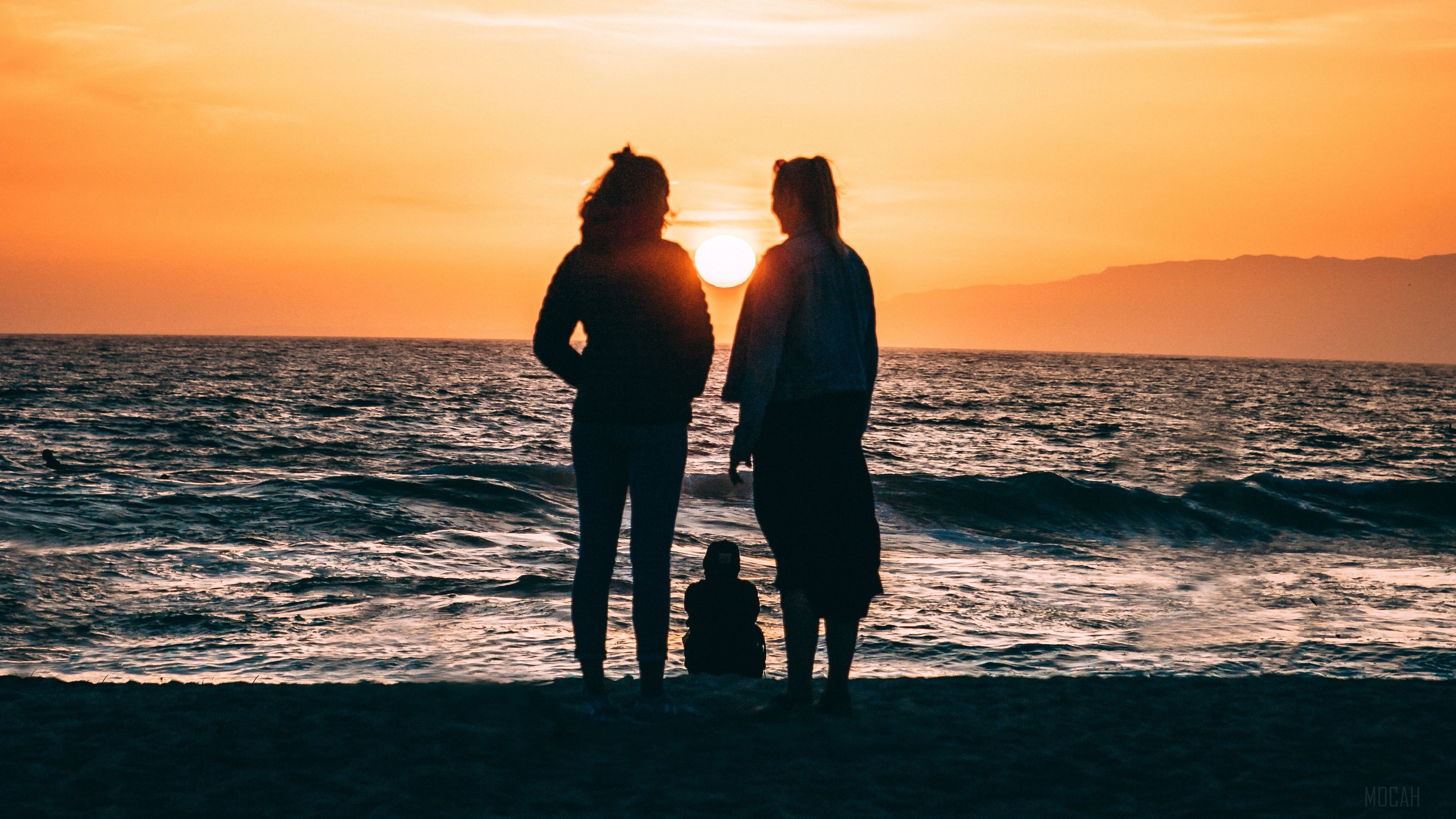 Family silhouettes on the shore at sunset 4K HD Wallpaper