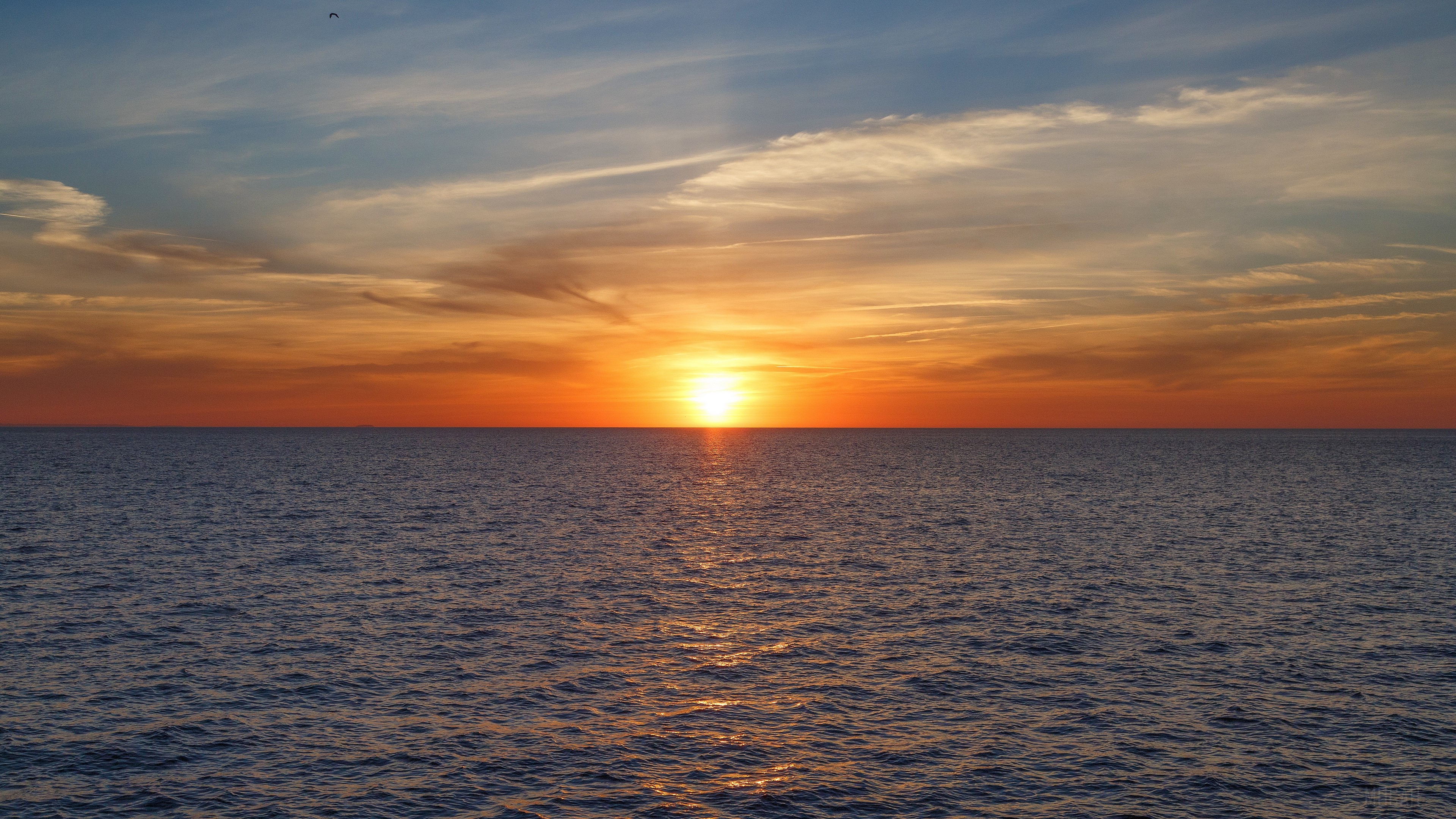Sunset over the sea with clouds 4K HD Wallpaper