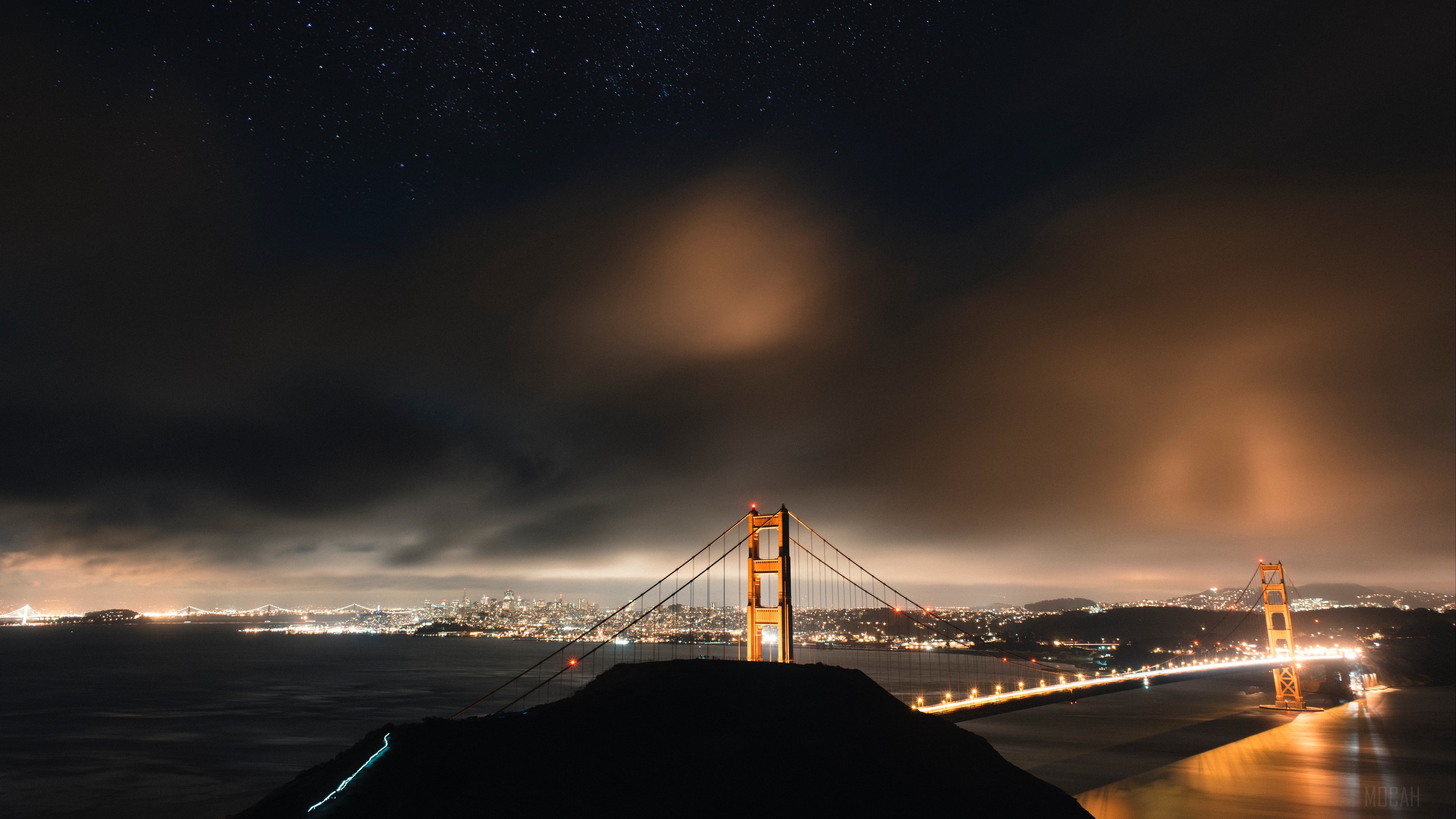 Golden Gate Bridge at night with San Francisco skyline and starry sky HD Wallpaper
