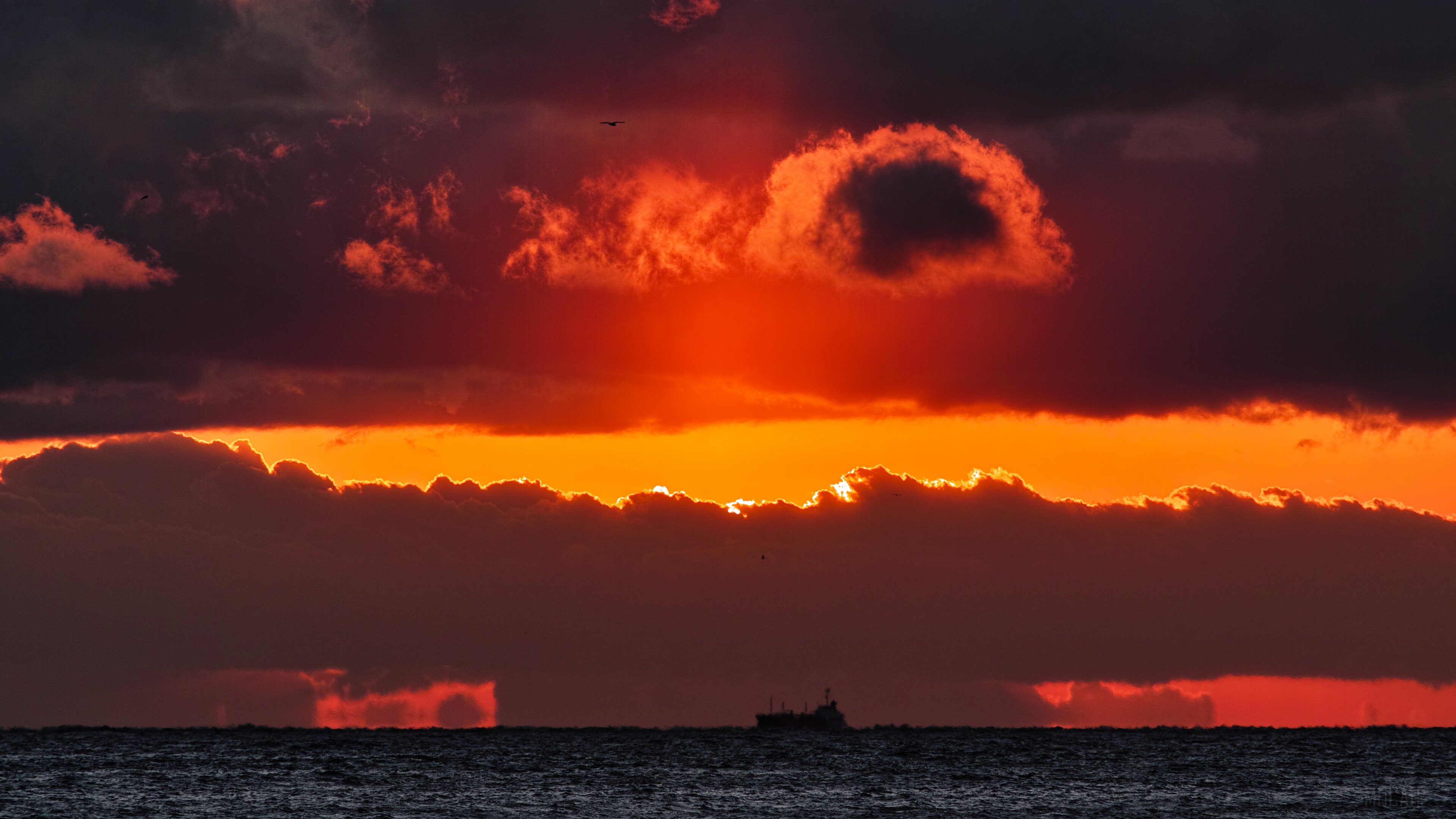 Sunset over the sea with clouds and ship 4K HD Wallpaper