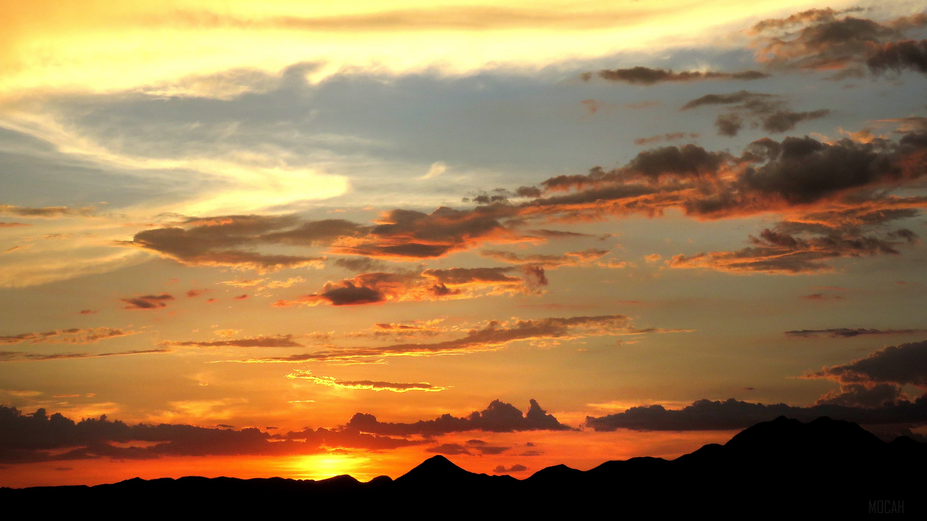 Sunset over mountains with clouds HD Wallpaper