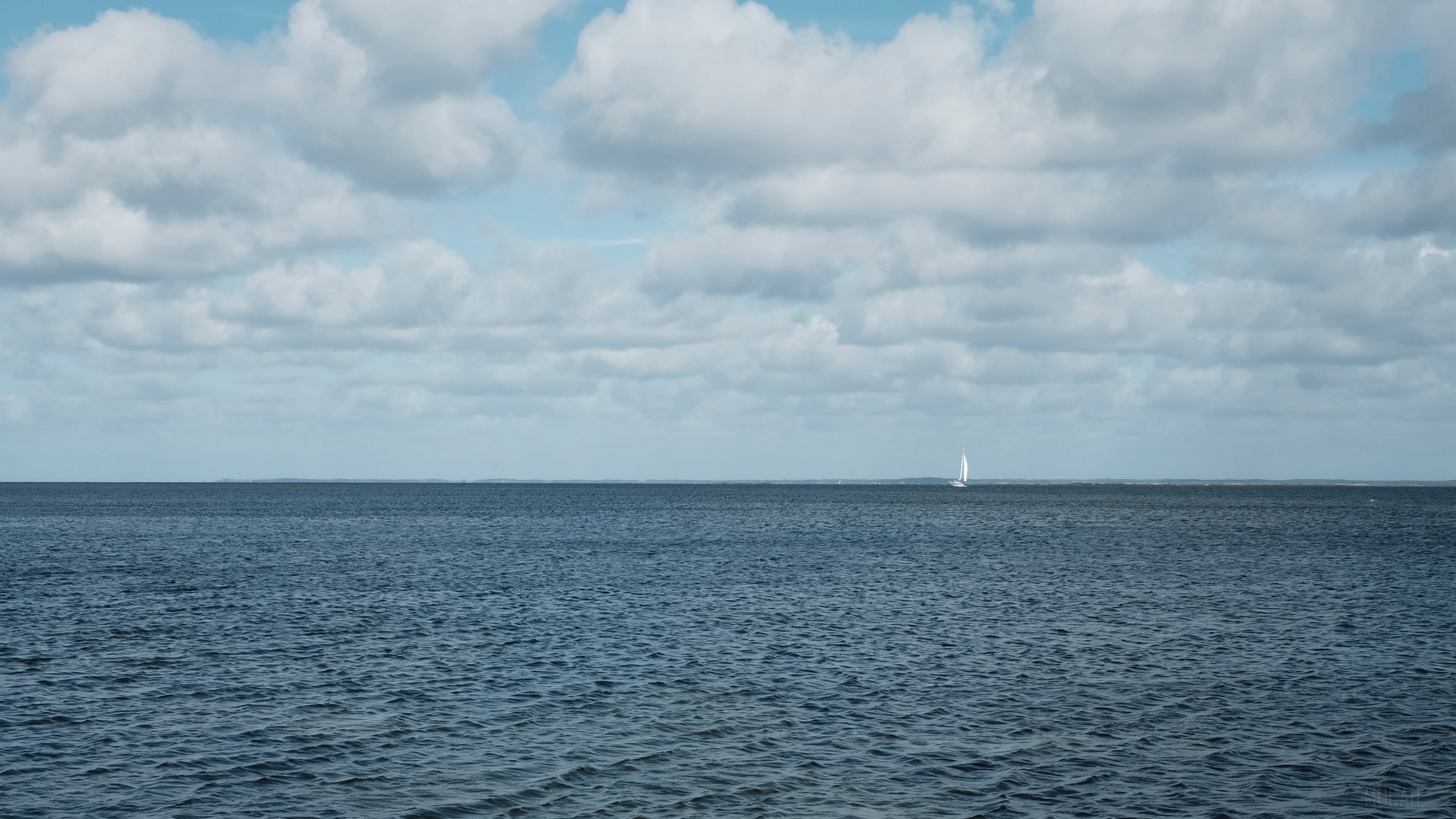 Sailboat on the sea under cloudy sky HD Wallpaper