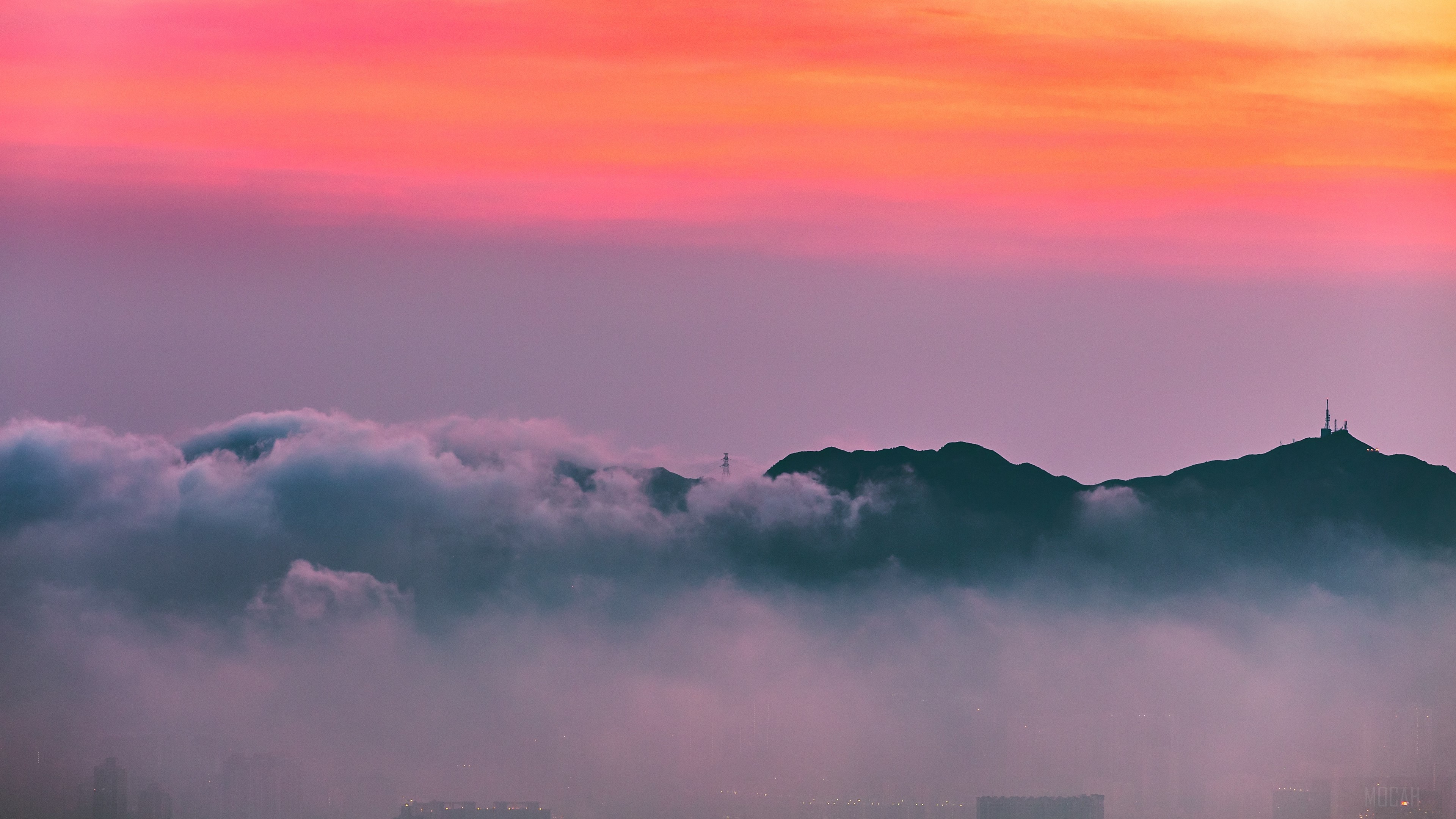 Mountain peaks shrouded in fog at sunrise HD Wallpaper