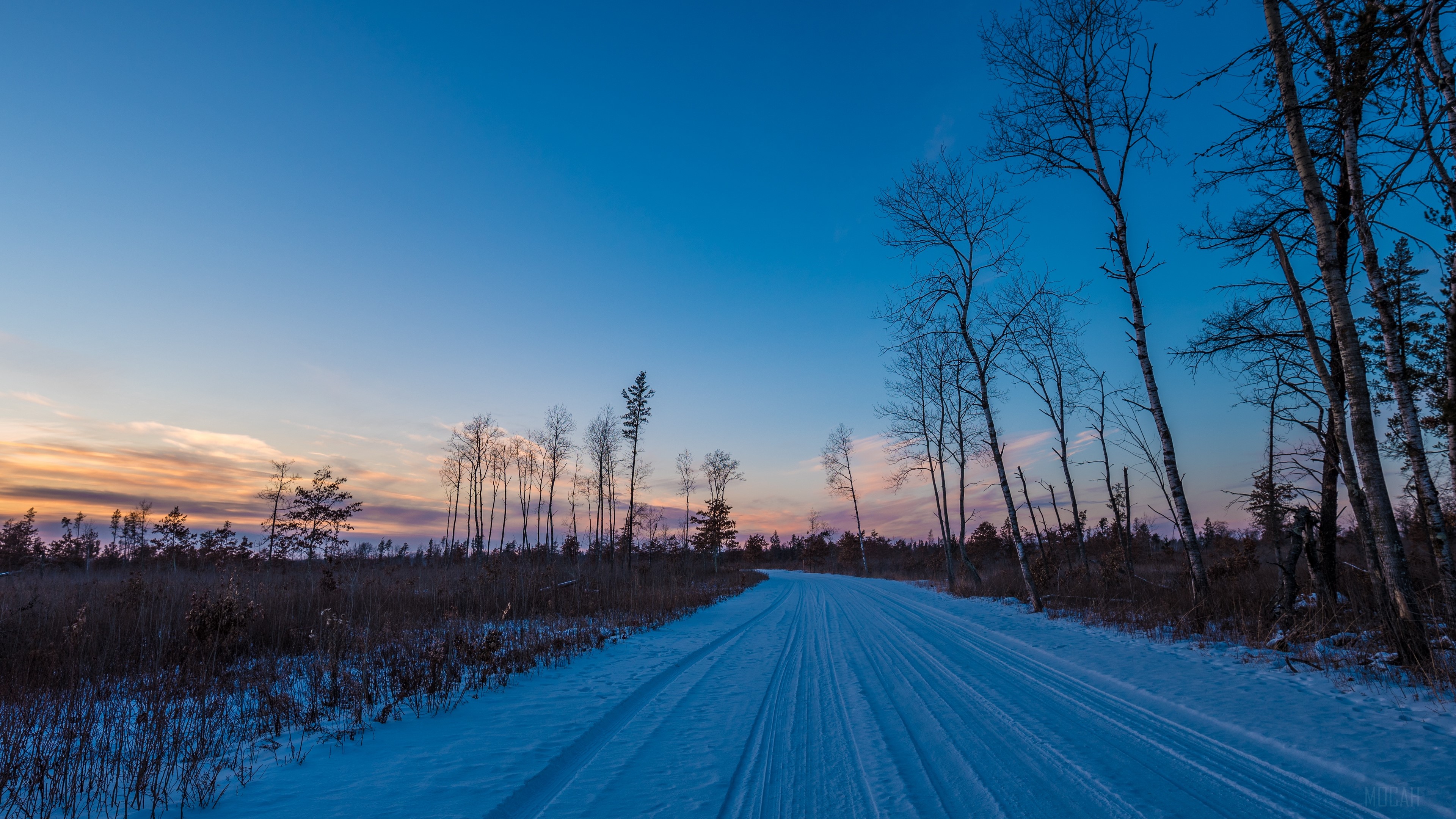 Winter road through trees at sunset 4K HD Wallpaper