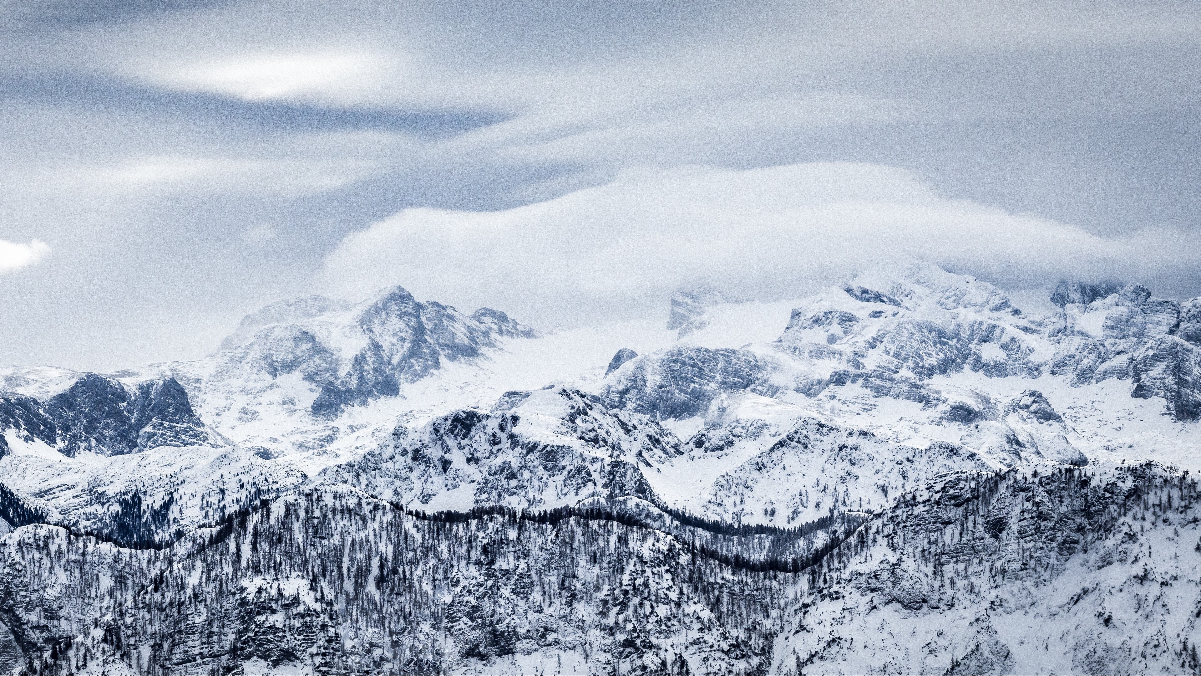 Snow-covered mountains with clouds and trees HD Wallpaper