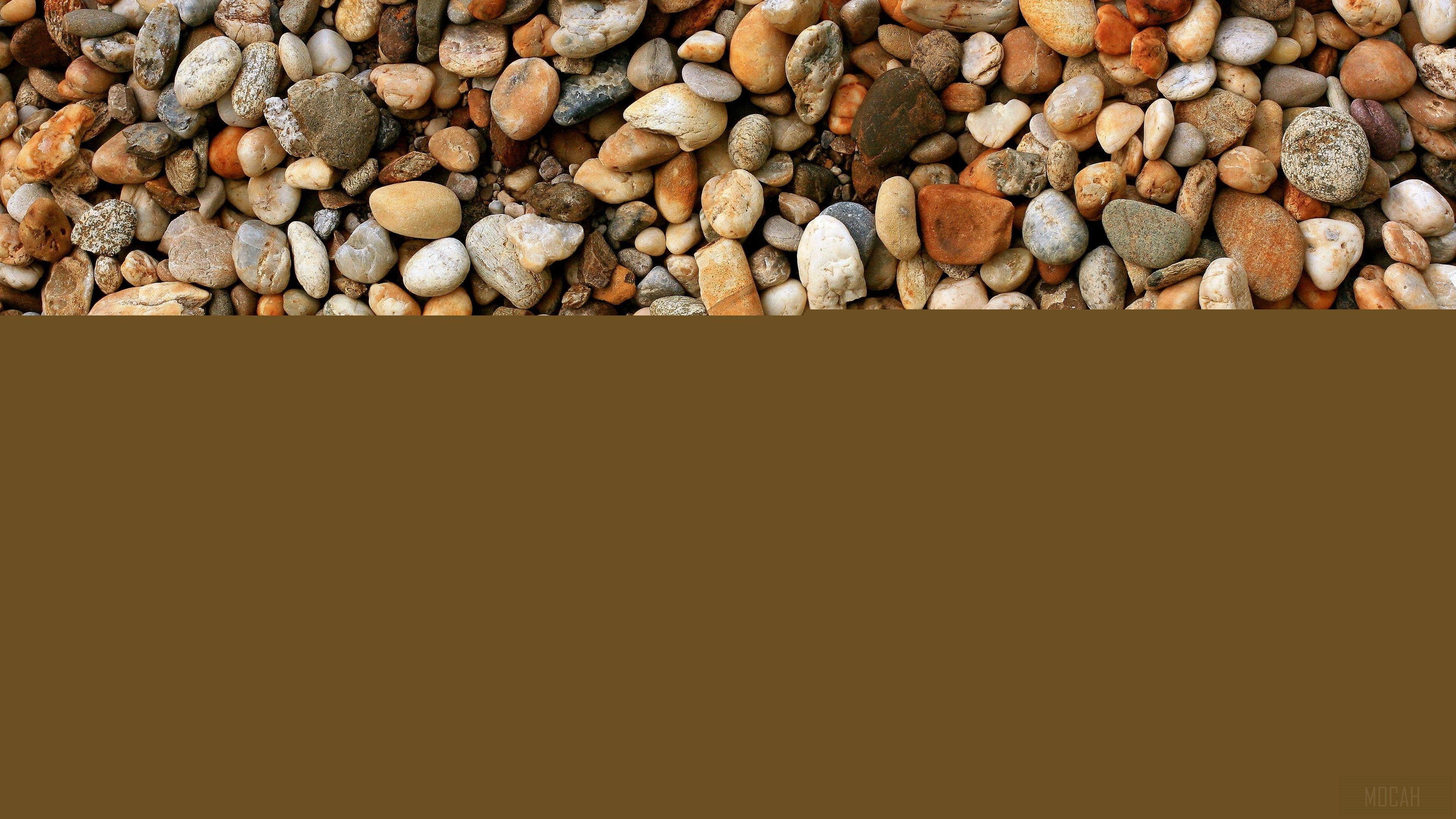 Pebbles and stones on a brown background HD Wallpaper