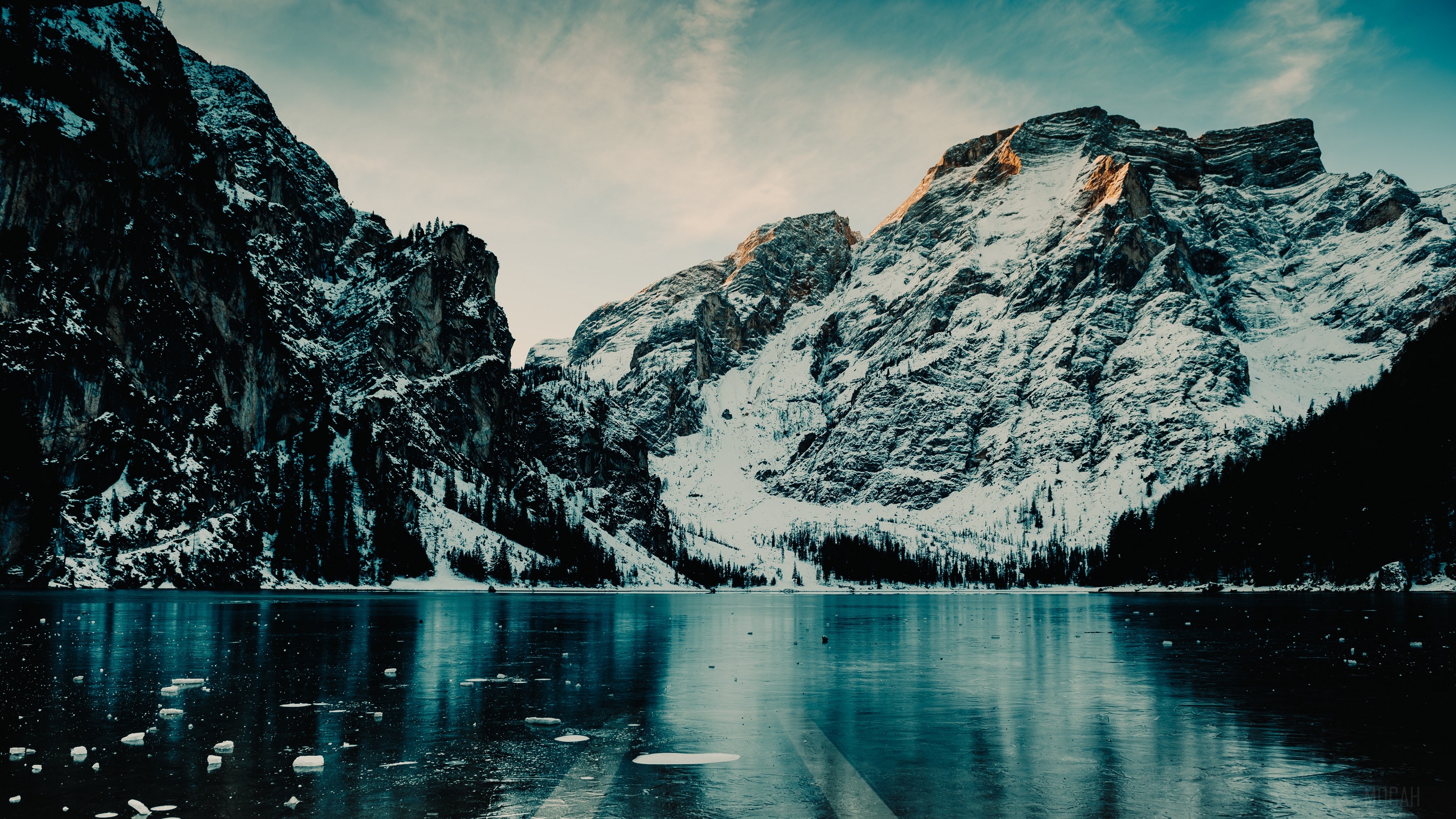 Snow-covered mountains reflected in a frozen lake in Italy HD Wallpaper
