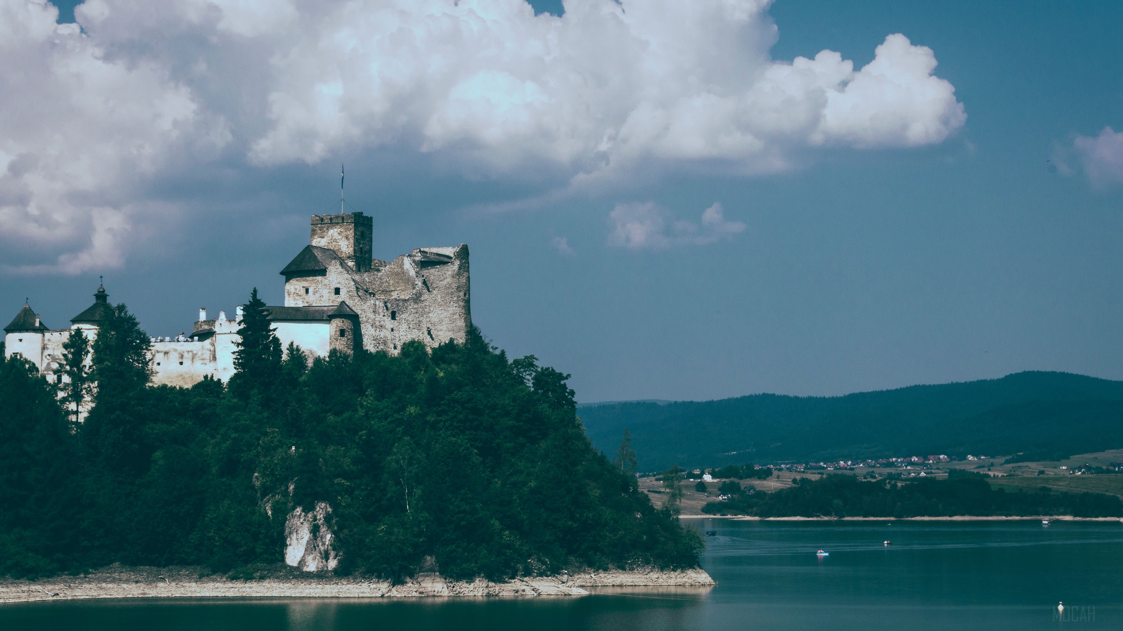 Castle on a hill overlooking a lake HD Wallpaper
