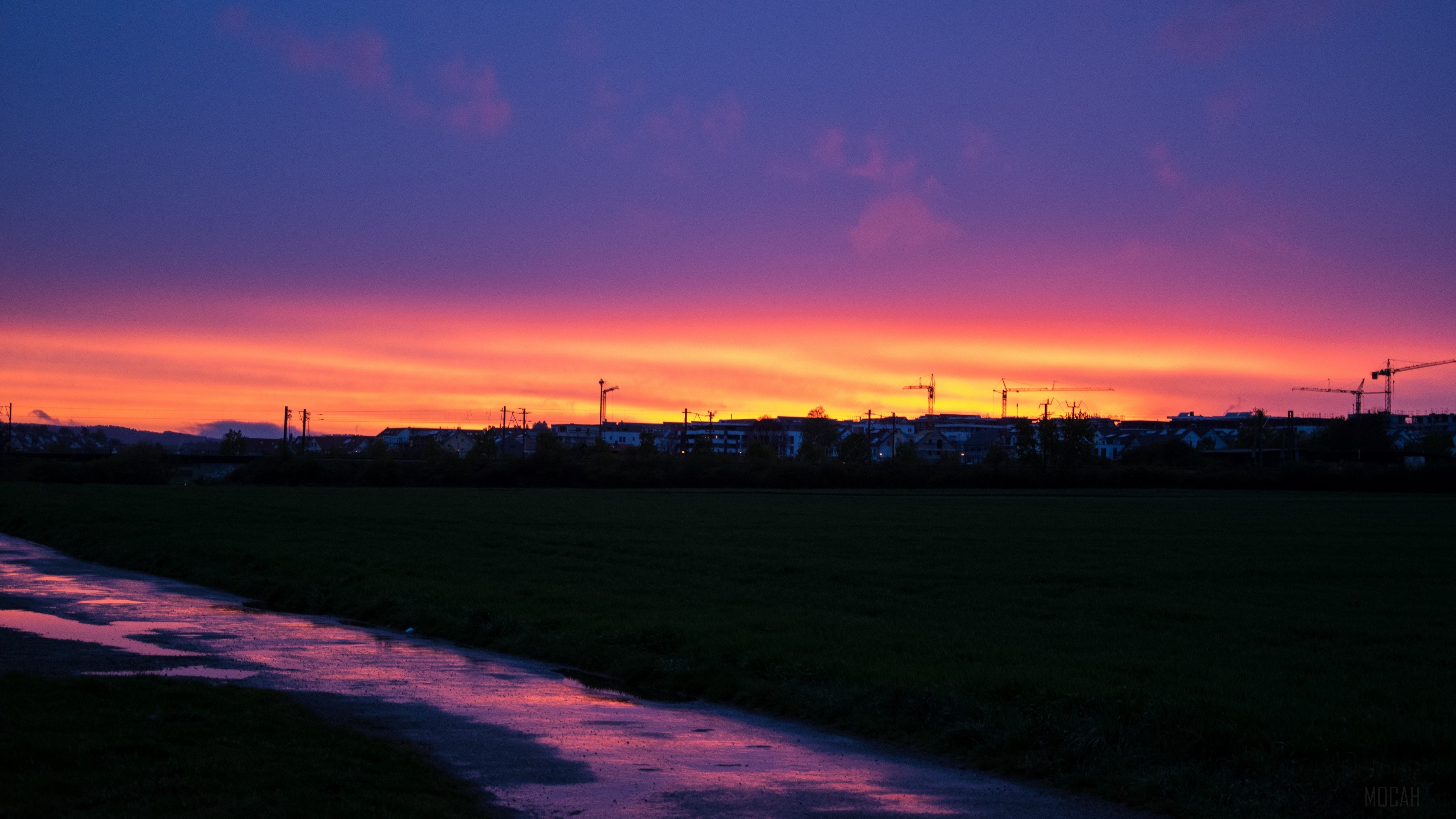 Sunset over construction site with wet path HD Wallpaper